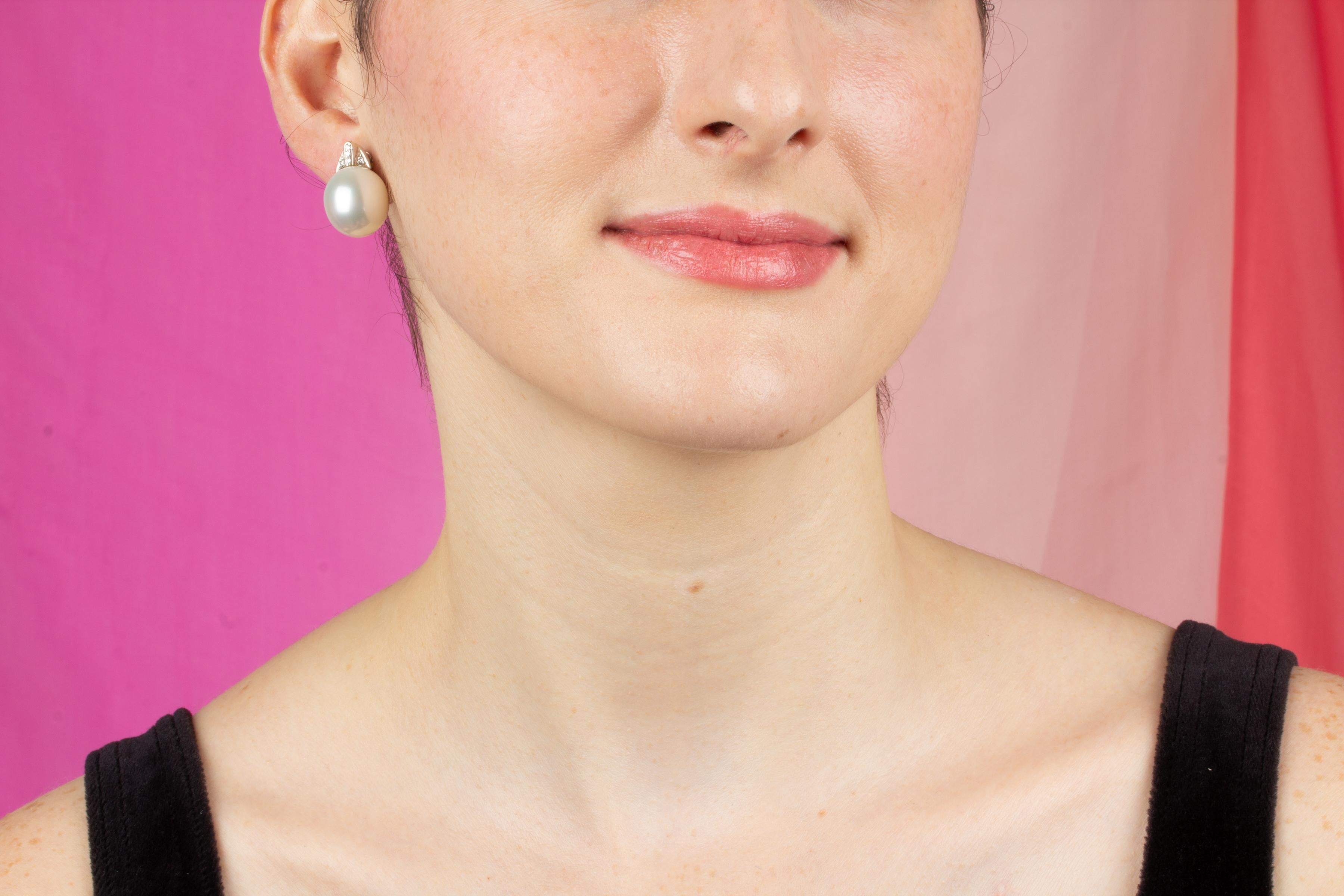 The South Sea pearl and diamond earrings feature two beautiful 15 x 16mm diameter South Sea pearls originating from the waters of Northwestern Australia. The untreated pearls are being delivered to the customer with their natural color and luster.