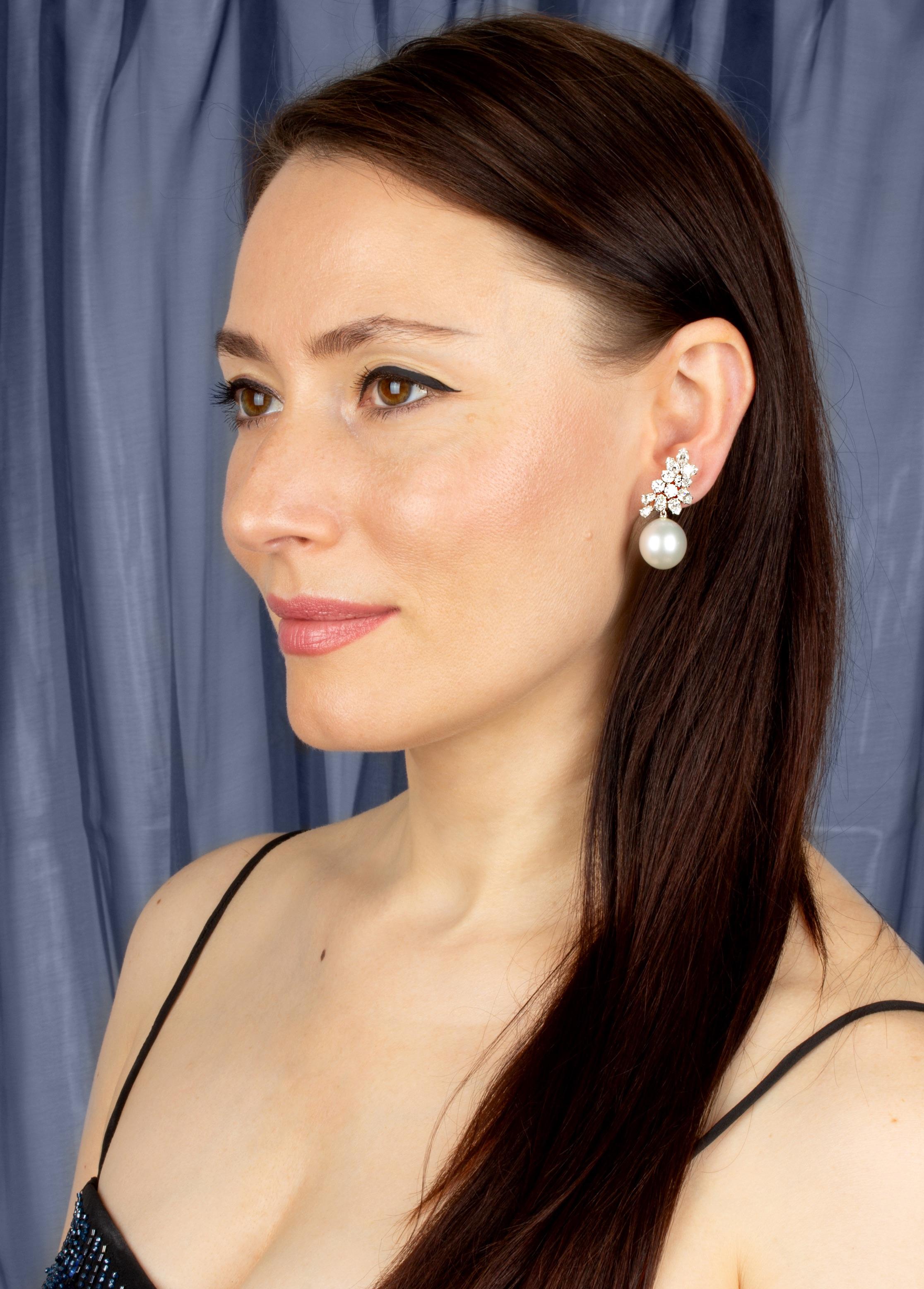 This pair of South Sea pearl and diamond earrings features a cluster design on the ear with a spray of pear shape (5.60 carats) and round (1.47) diamonds of top quality (F-G/VVS). The tops suspend 2 gem- quality South Sea pearls of 16 x 15mm.
All of