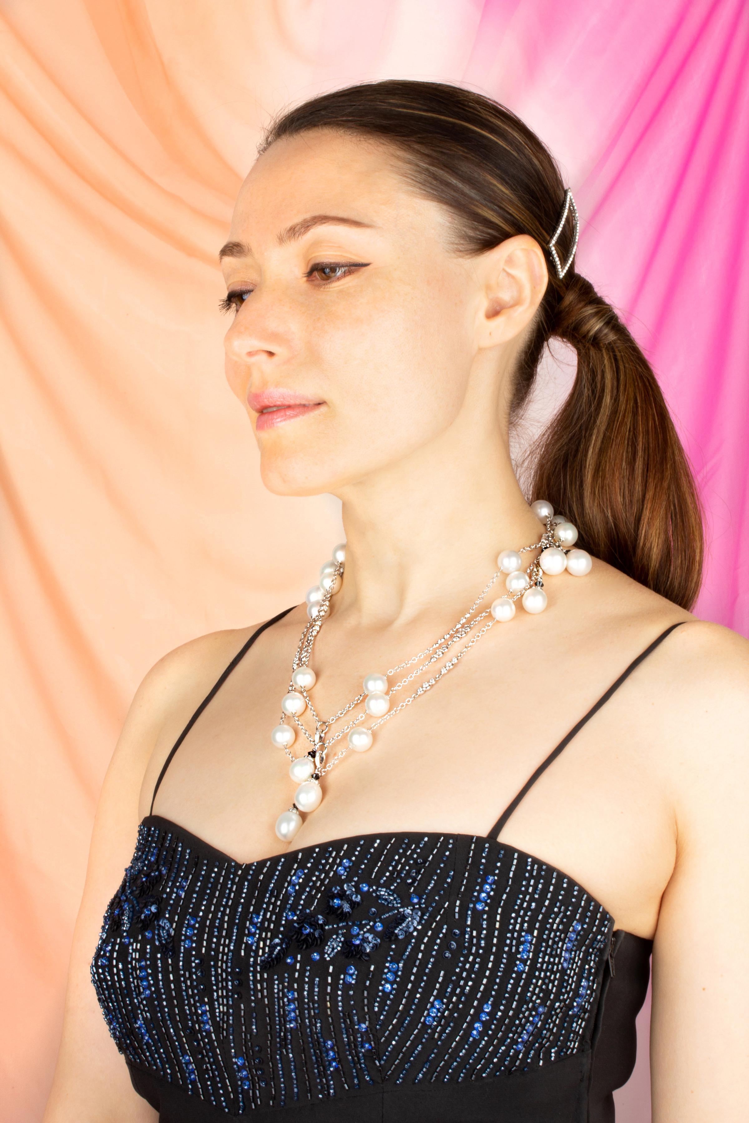 The pearl and diamond sautoir necklace (61” long ) features a symmetrical arrangement of 18 Australian South Sea pearls interleaved at regular intervals by diamond motifs. 9 detachable South Sea pearl pendants with diamond tops accented with black