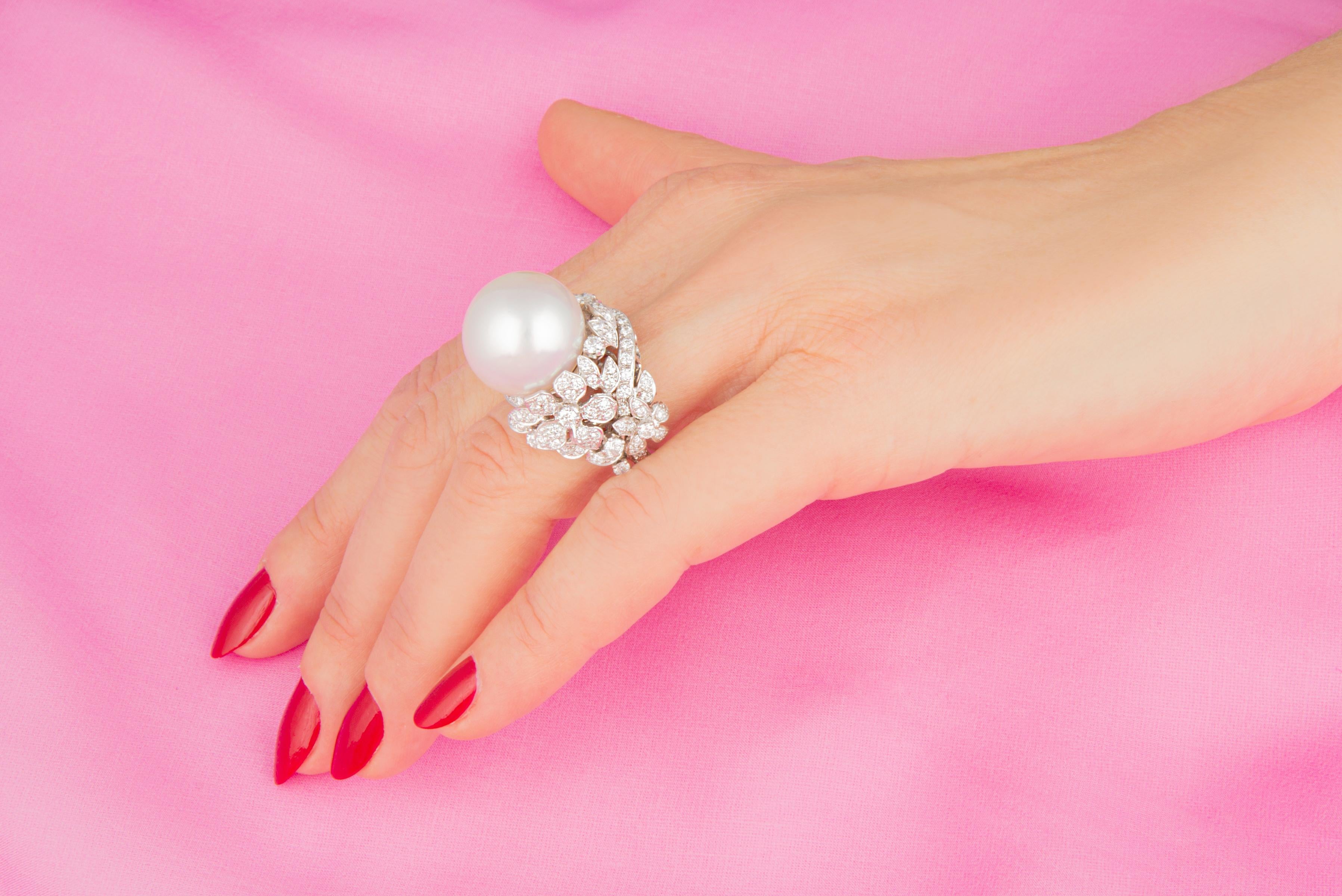 This South Sea pearl and diamond cocktail ring features a gem quality pearl of pinkish hues and 17.5mm diameter. The pearl is untreated. It displays a splendid nacre and its natural color and luster have not been enhanced in any way. The pearl is