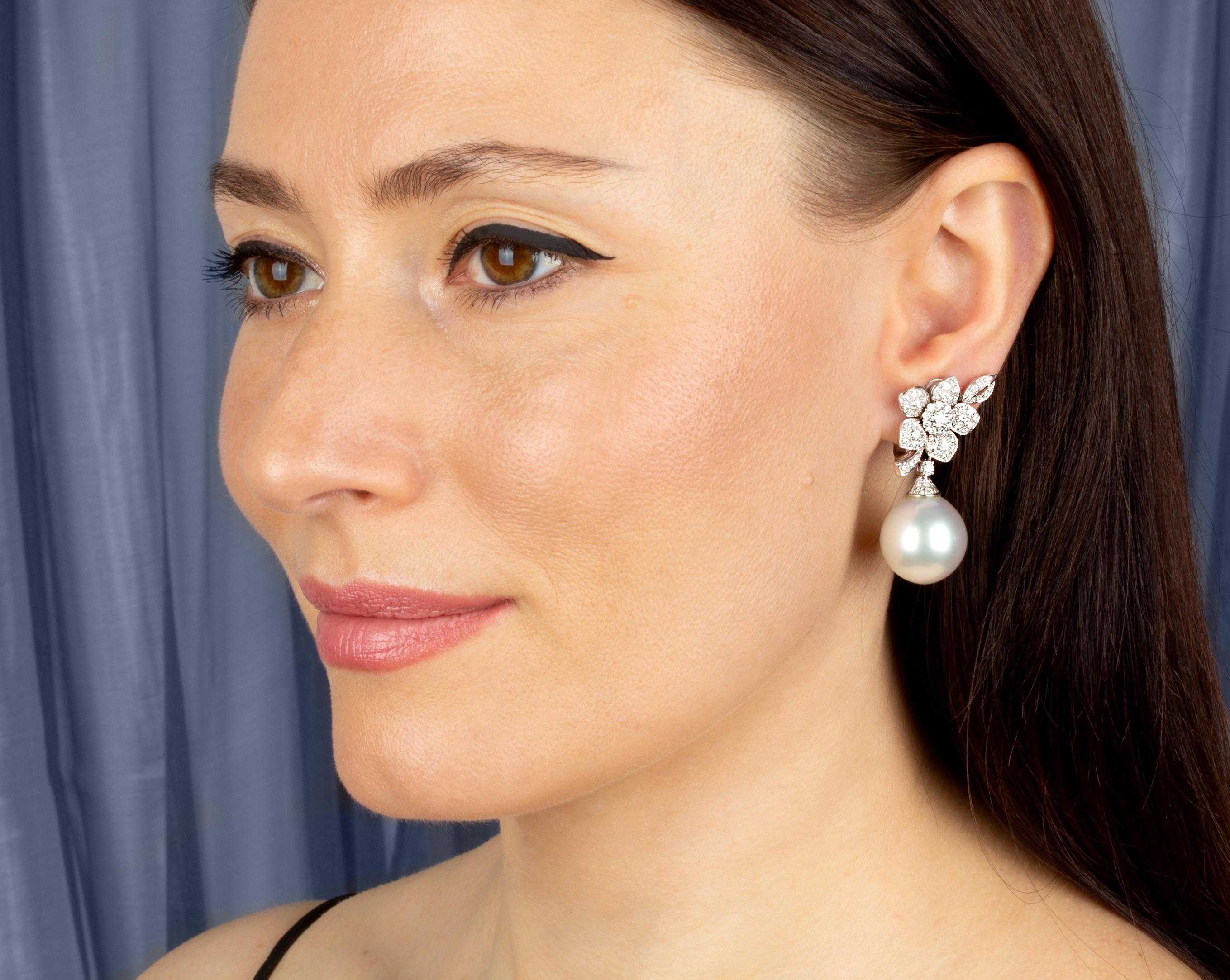The South Sea pearl and diamond earrings features a flower design on the ear set with 1.90 carats of round diamonds. 
The tops suspend a pair of splendid South Sea pearls of the unusual size of 18.5mm diameter. 
All of our pearls are untreated: