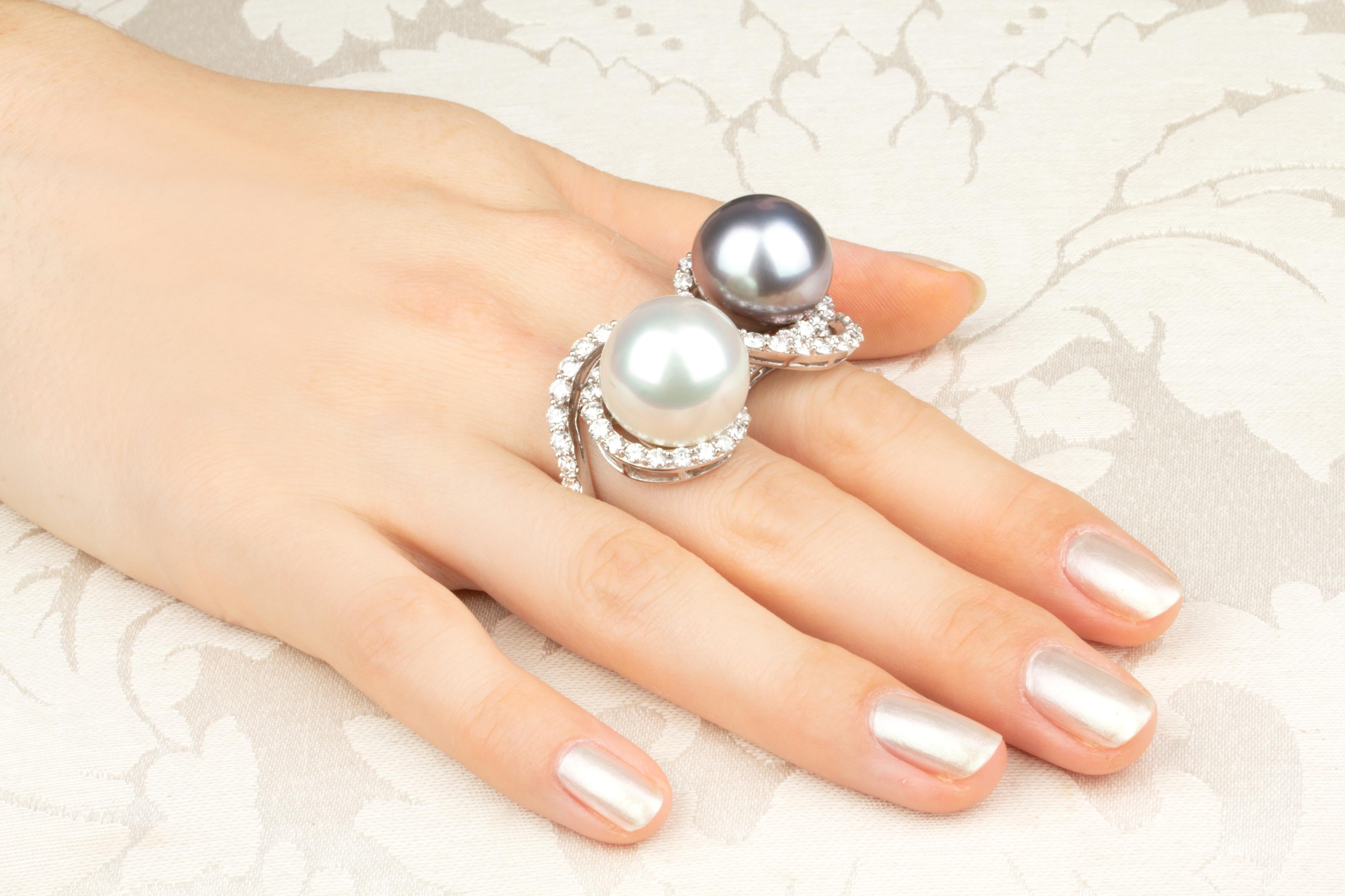 This pearl and diamond two-finger ring features a splendid South Sea pearl of 17.8mm diameter, and an equally splendid Tahitian pearl of 17.5mm diameter. The pearls are untreated. They display a fine nacre and their natural color and luster have not