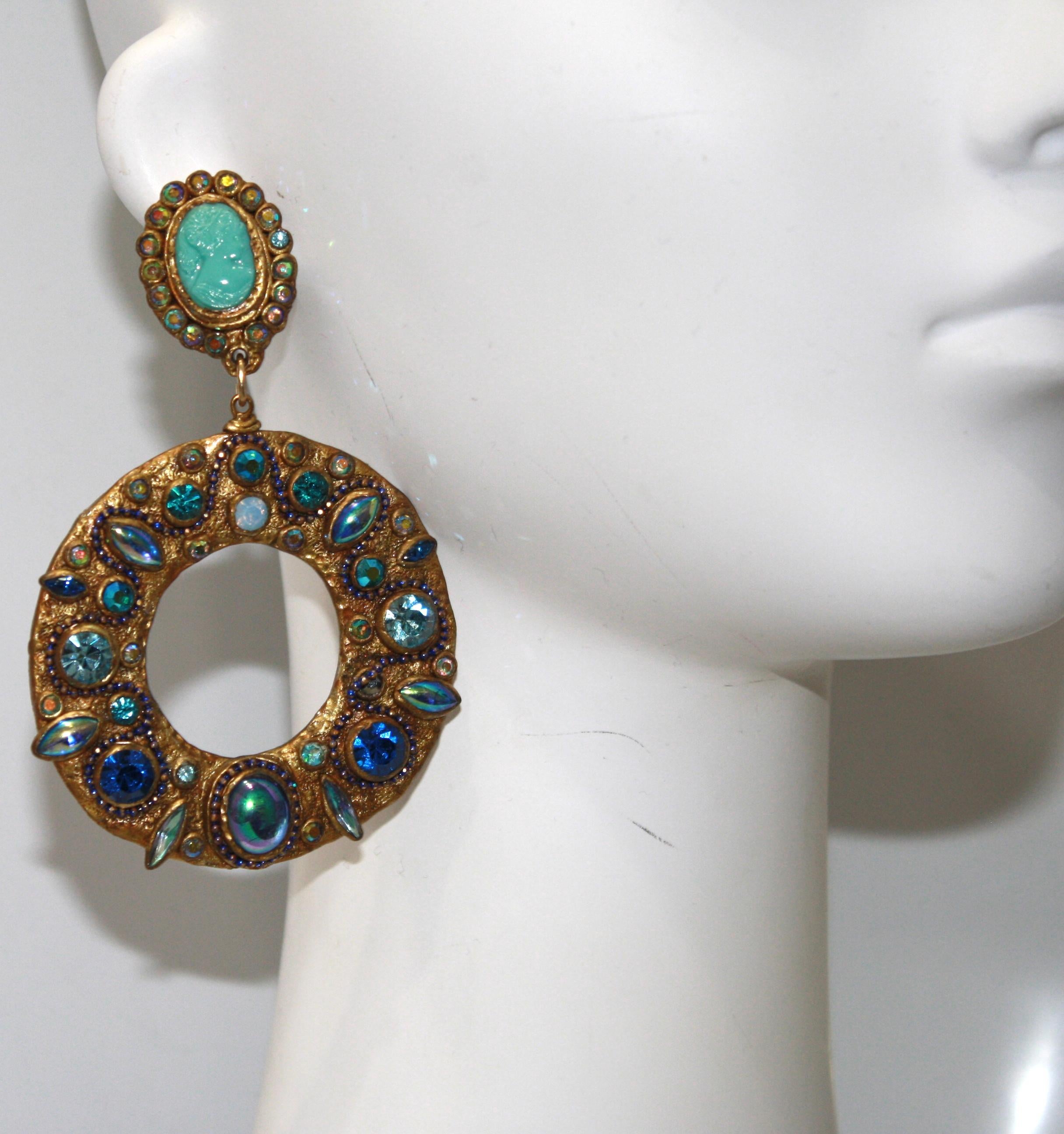 Large loops made of papier-mâché set with Swarovski crystal. Vintage turquoise cameo on clip.