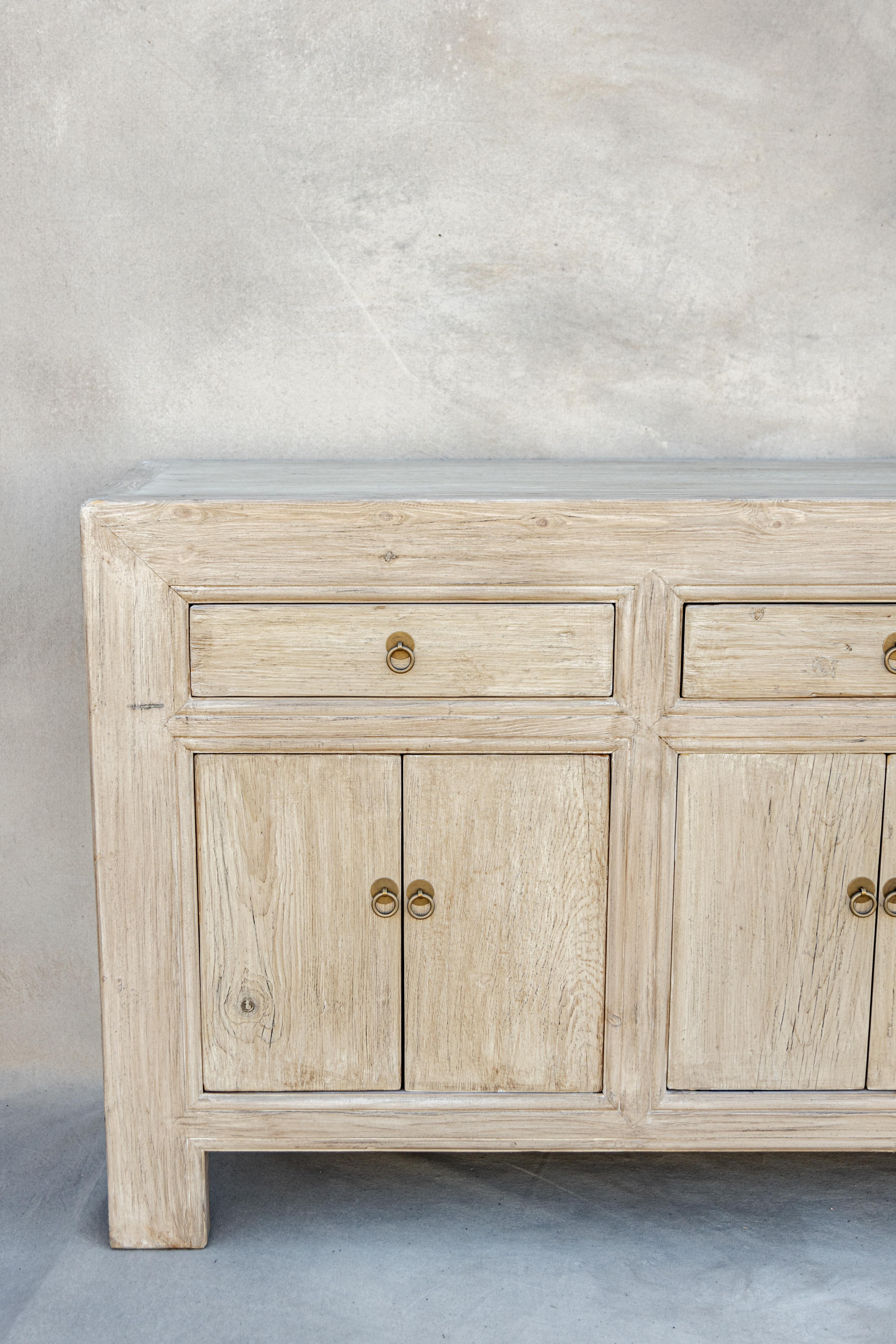 Introducing our Ella sideboard. She has four drawers and eight doors. Crafted from vintage elm wood sourced throughout Europe and Asia. Her aesthetic is vintage inspired with stunning, one of a kind rustic textures. She would be beautifully styled