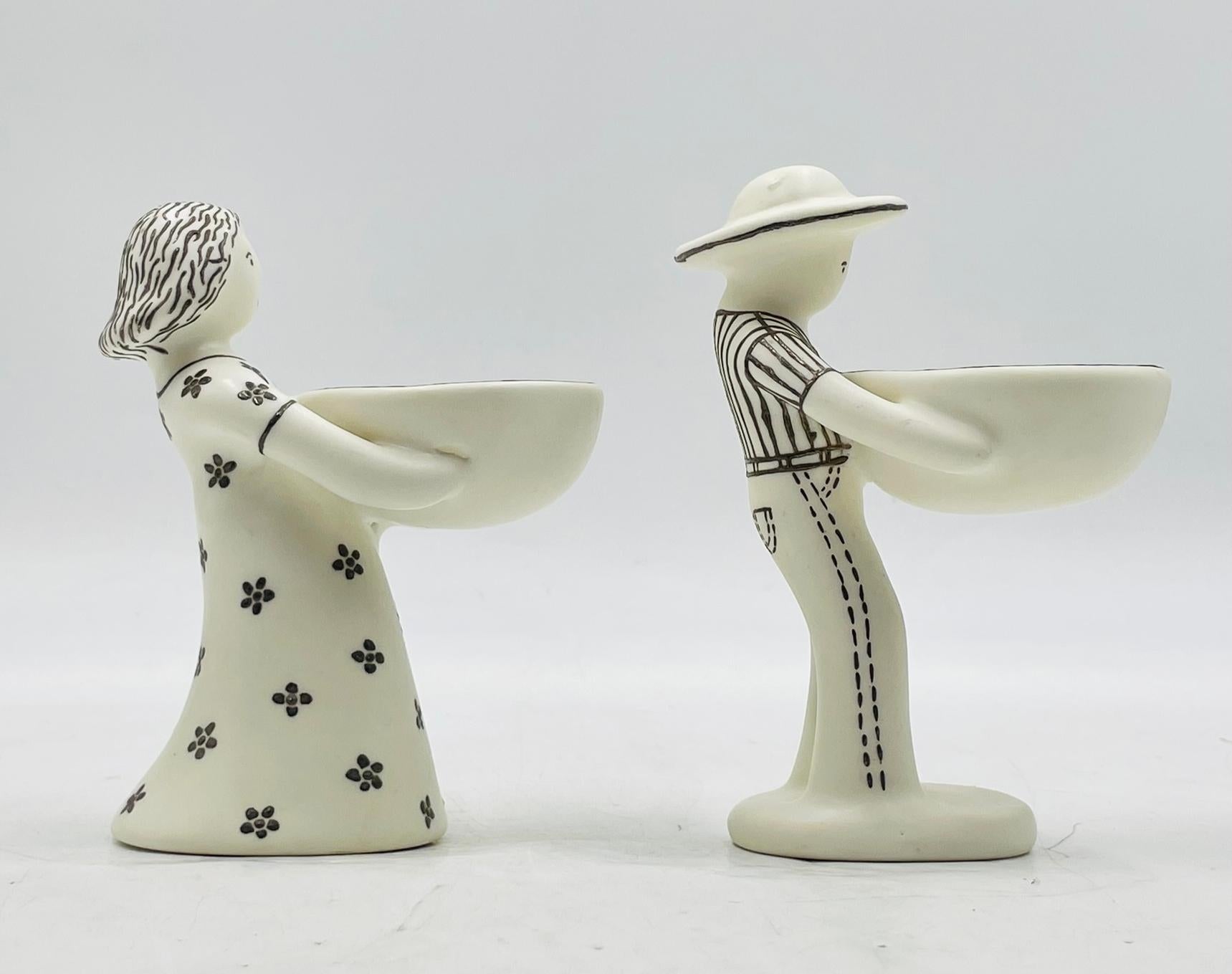 A charming and signed pair of figural table sculptures by acclaimed Mexican artist Emilia Castillo, titled “Ella y Él” and dated 1995. Crafted in fine porcelain with hand-applied pure silver accents, these whimsical figures—a man and a woman—each