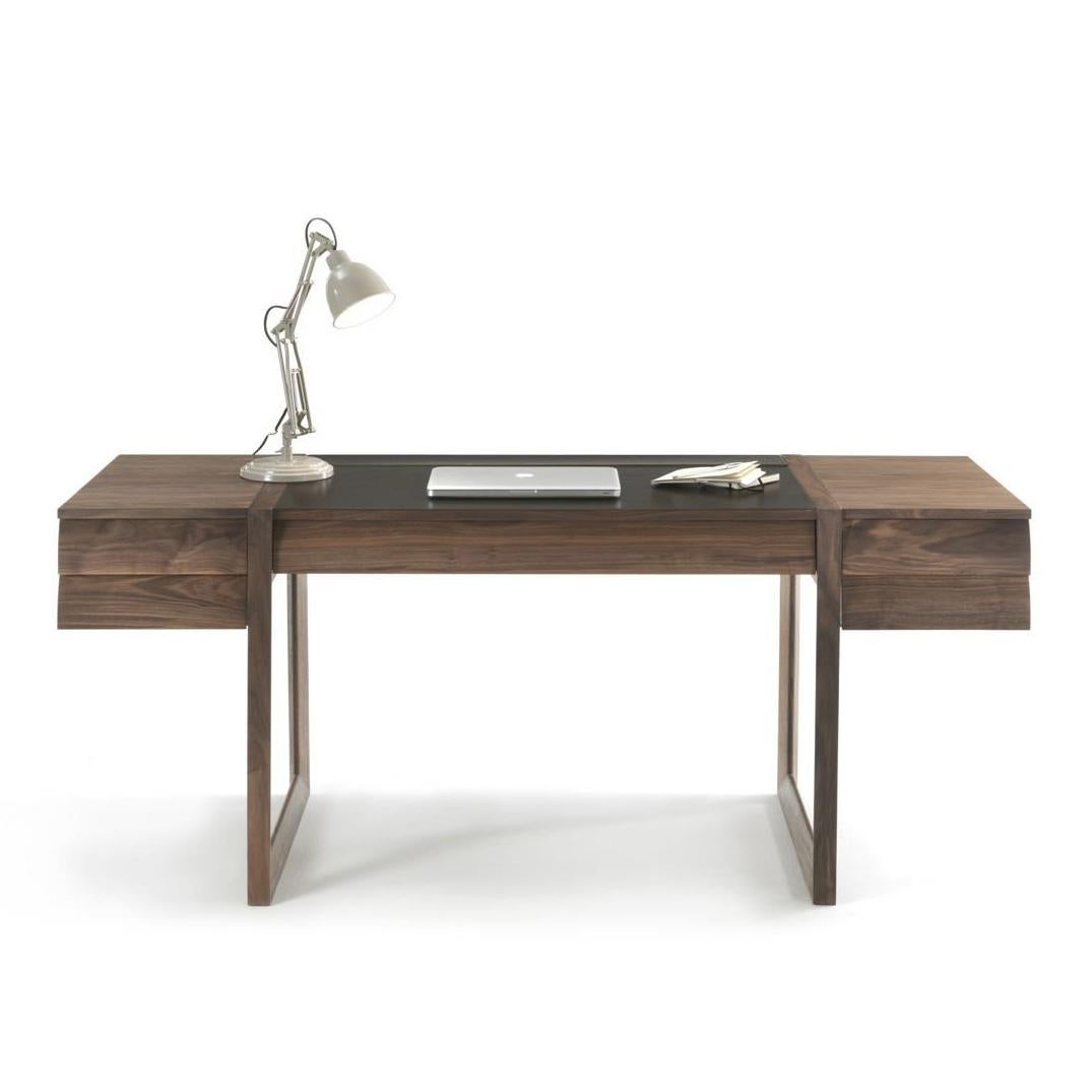 The Elle Ecrit Desk is designed with sleek, rectangular contours and enhanced functionality, featuring a central drawer flanked by two sets of side drawers. Its top includes a sliding compartment that unveils a storage area for personal items.