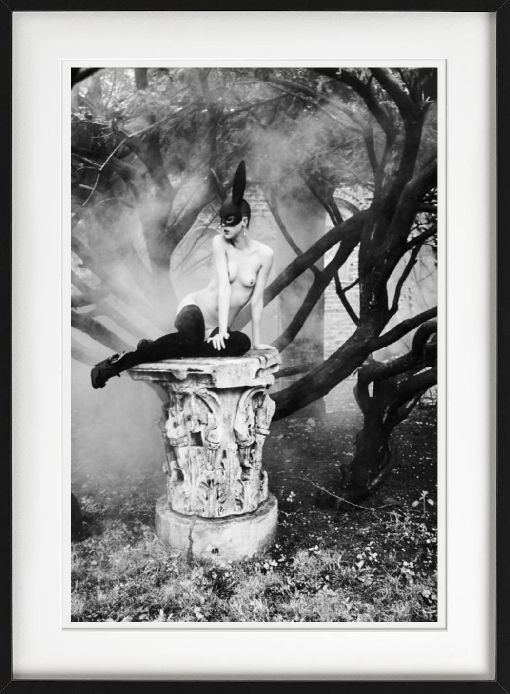 Bunny on pedestal - nude model with bunny ears - Gray Black and White Photograph by Ellen von Unwerth