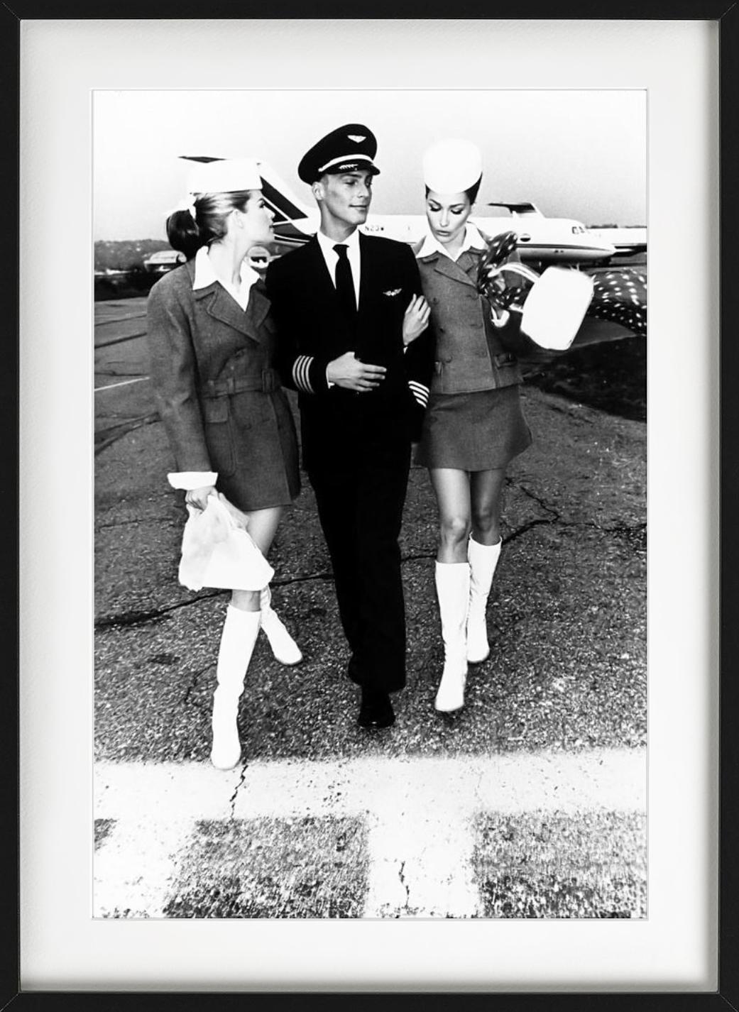 Black and white photography of the pilot and his stewardesses getting off the plane, photographed by Ellen von Unwerth.

All prints are limited edition. Available in multiple sizes. High-end framing on request.

All prints are done and signed by the