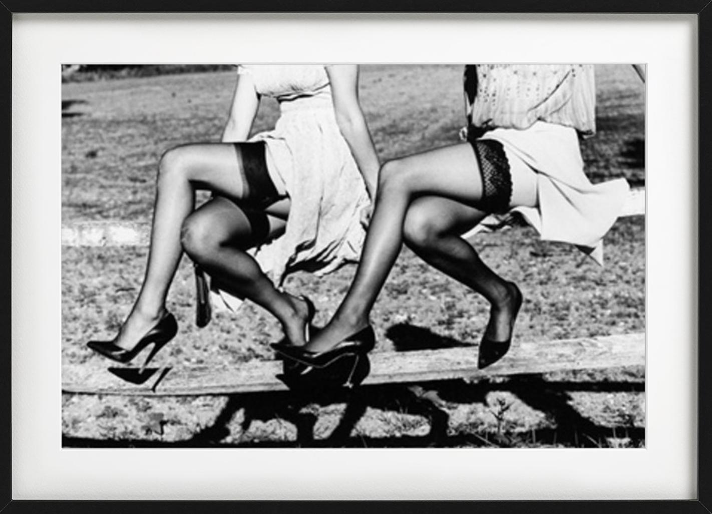 Leg Show II - Models in Stockings sitting on a fence, fine art photography, 2002 - Photograph by Ellen von Unwerth