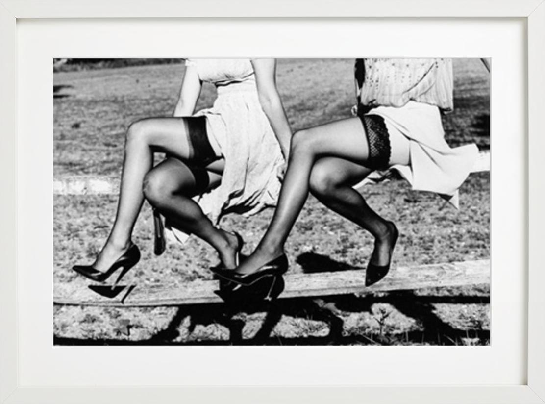 Leg Show II - Models in Stockings sitting on a fence, fine art photography, 2002 - Gray Figurative Photograph by Ellen von Unwerth
