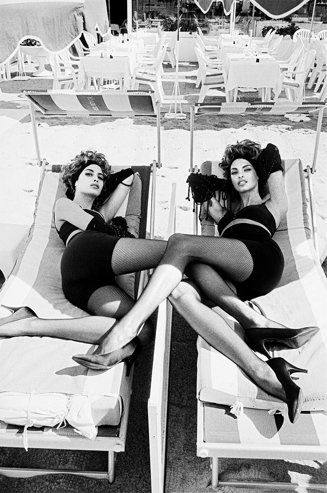 Ellen von Unwerth Black and White Photograph - Legs Crossed: Christy Turlington and Linda Evangelista, Cannes, 1990