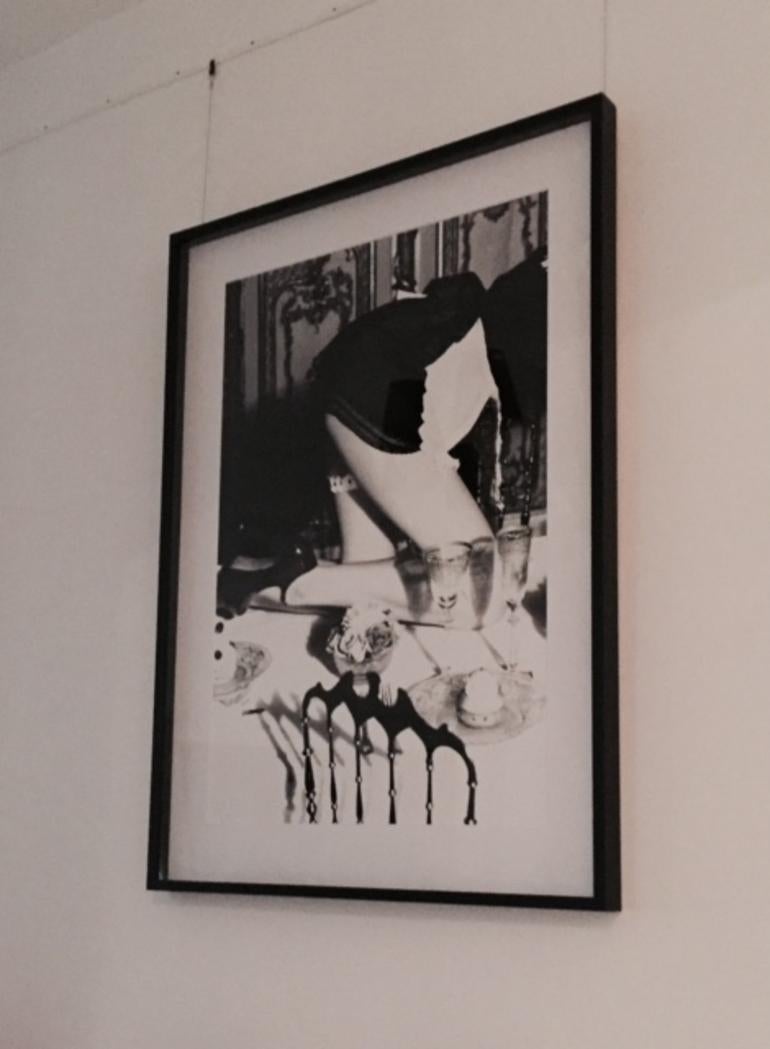 Maid - crawling over a set dinner table in vintage look - Photograph by Ellen von Unwerth