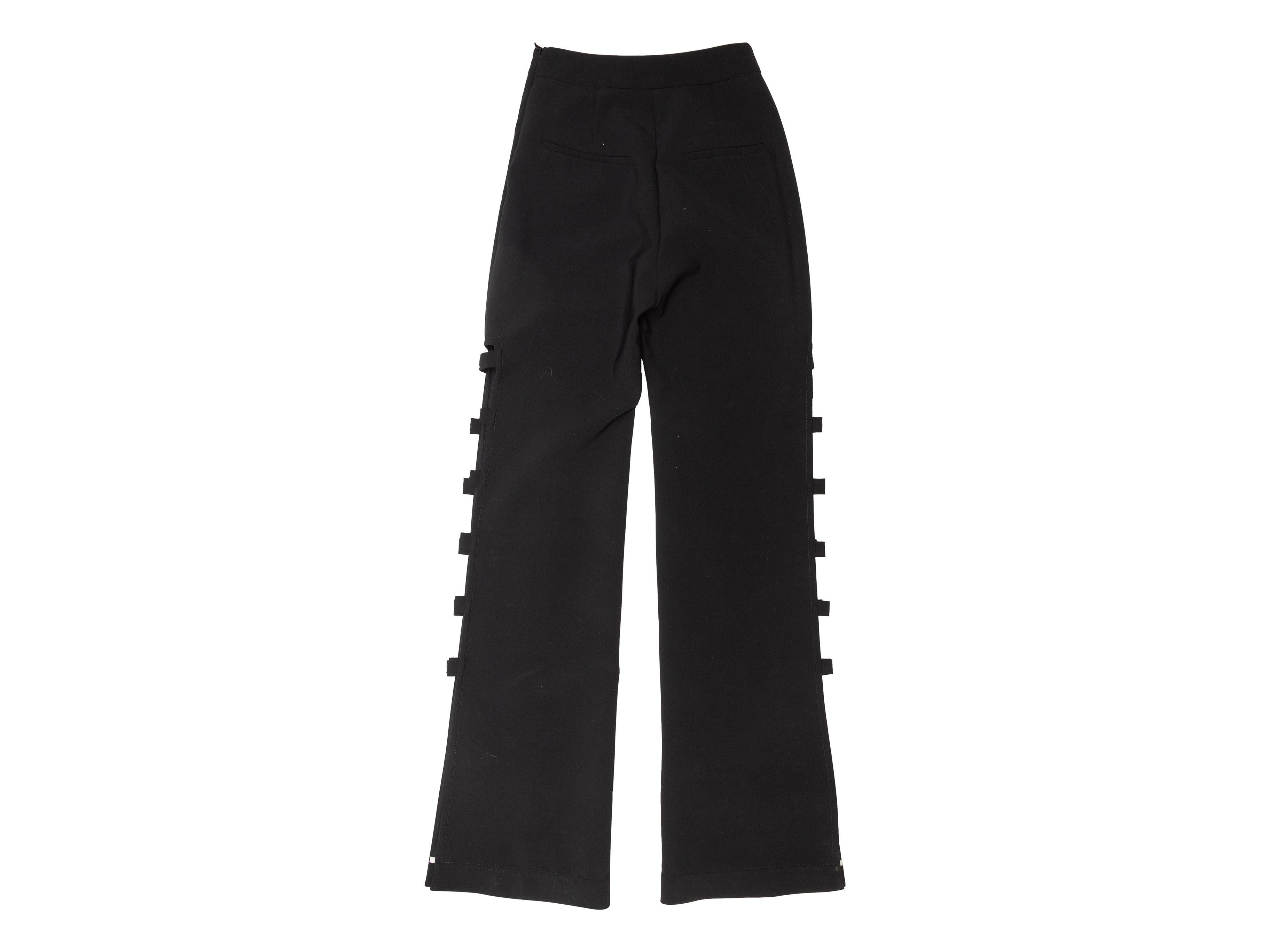 Product details: Black high-rise trousers by Ellery. Cutouts at outer sides of legs. Zip closure at side. 24