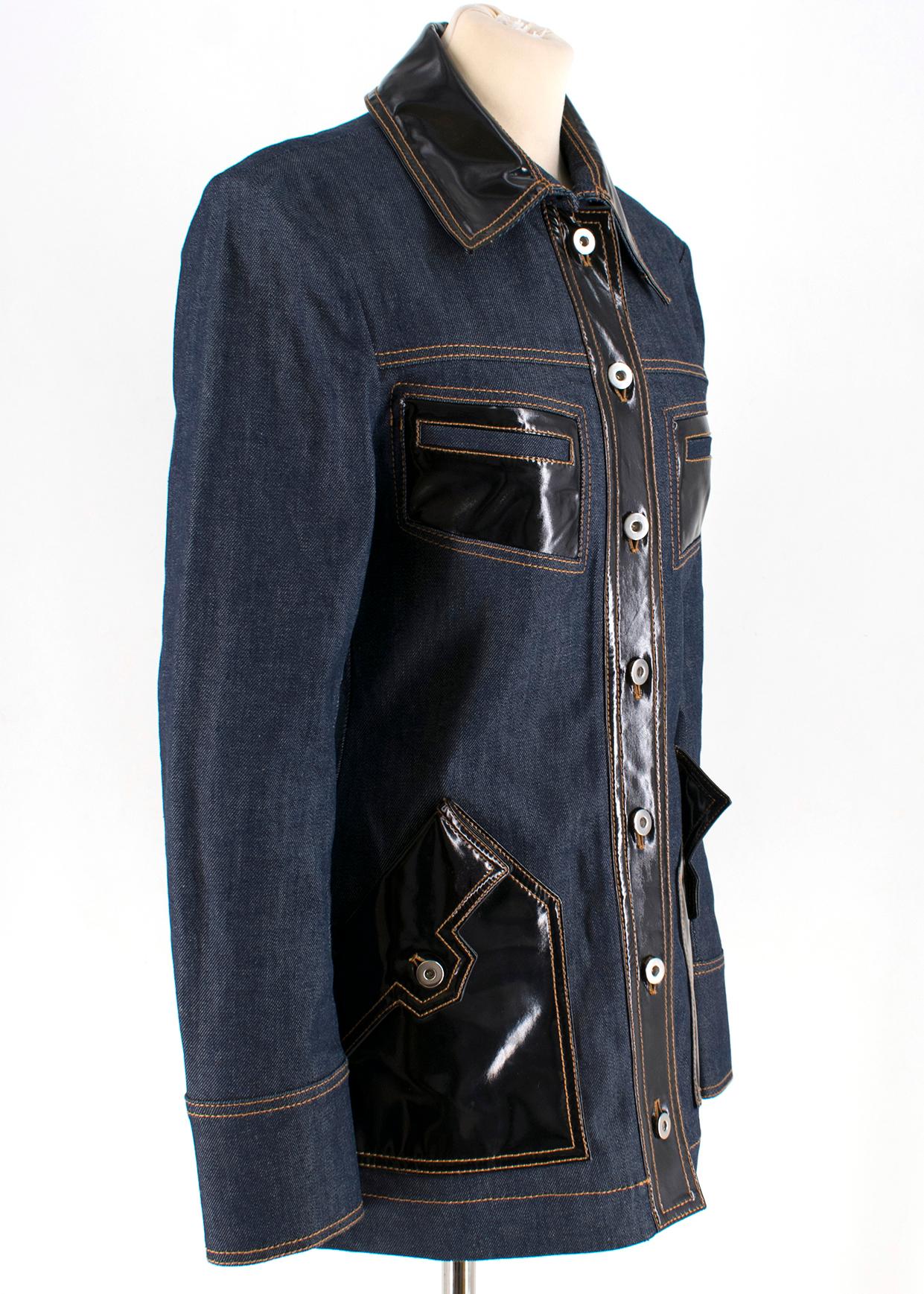 Ellery Vinyl-Panel Denim Jacket

- blue denim jacket 
- black vinyl embellishment to the front pockets and collar
- button fastening to the front
- flap pockets to the front
- unlined

Please note, these items are pre-owned and may show some signs