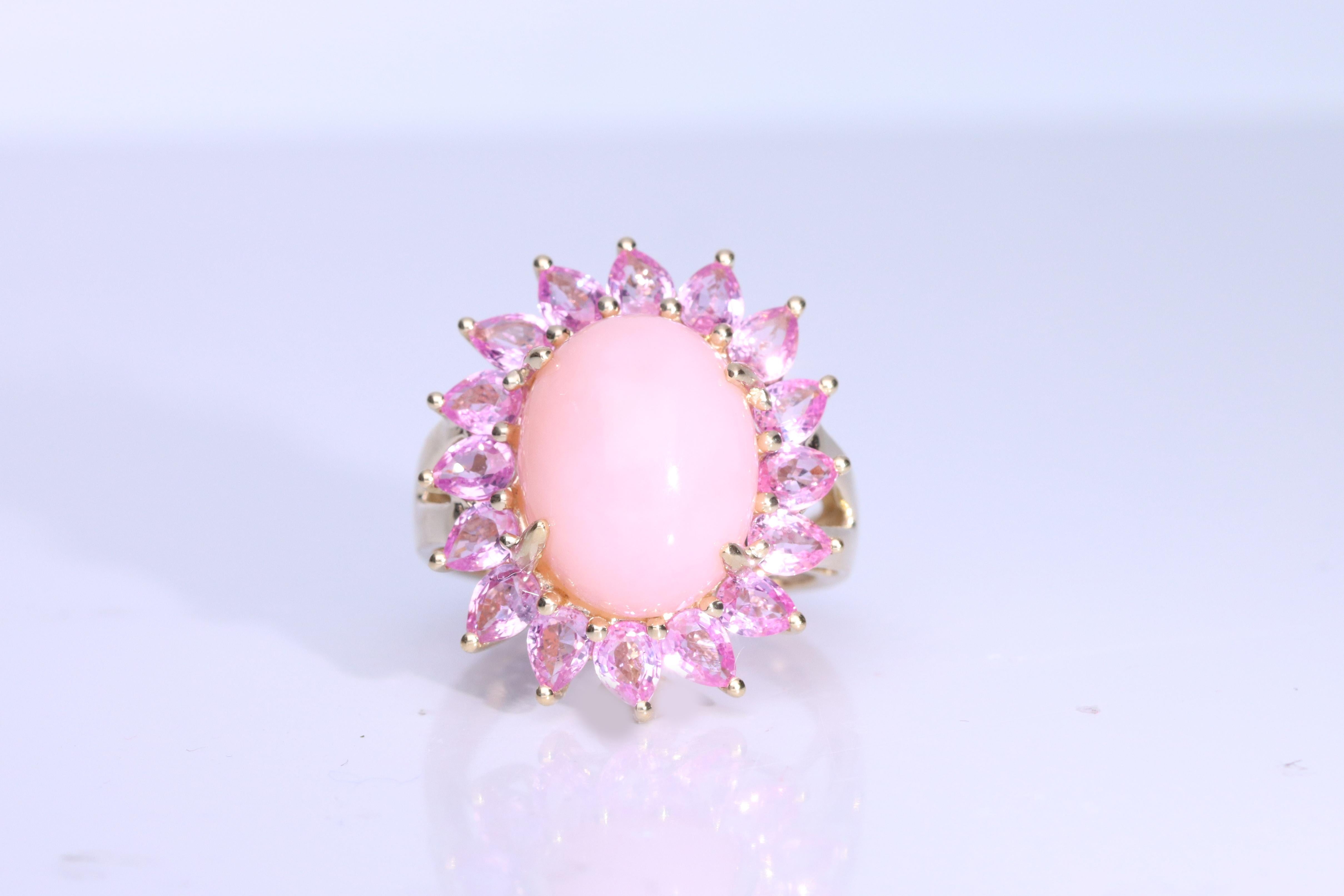 Decorate yourself in elegance with this Ring is crafted from 14K Yellow Gold by Gin & Grace. This Ring is made up of 11x14 mm Oval-Cab (1 pcs) 5.49 carat Pink Opal and Round-cut Pink-Sapphire (16 pcs) 2.85 carat. This Ring is weight 4.51 grams. This