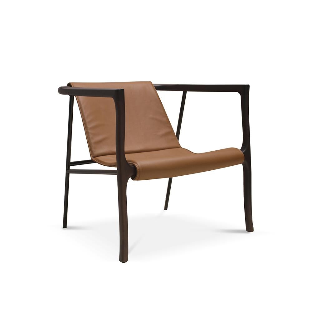 Elliot Armchair by Collector
Materials: Solid oak wood armrests.
Black Lacquerd Metal frame structure. Uphostered in genuine Sequoia 4001 leather.
Dimensions: W 85 x D 75 x H 72 cm
SH 44 cm 

With solid and curved wooden armrests, this