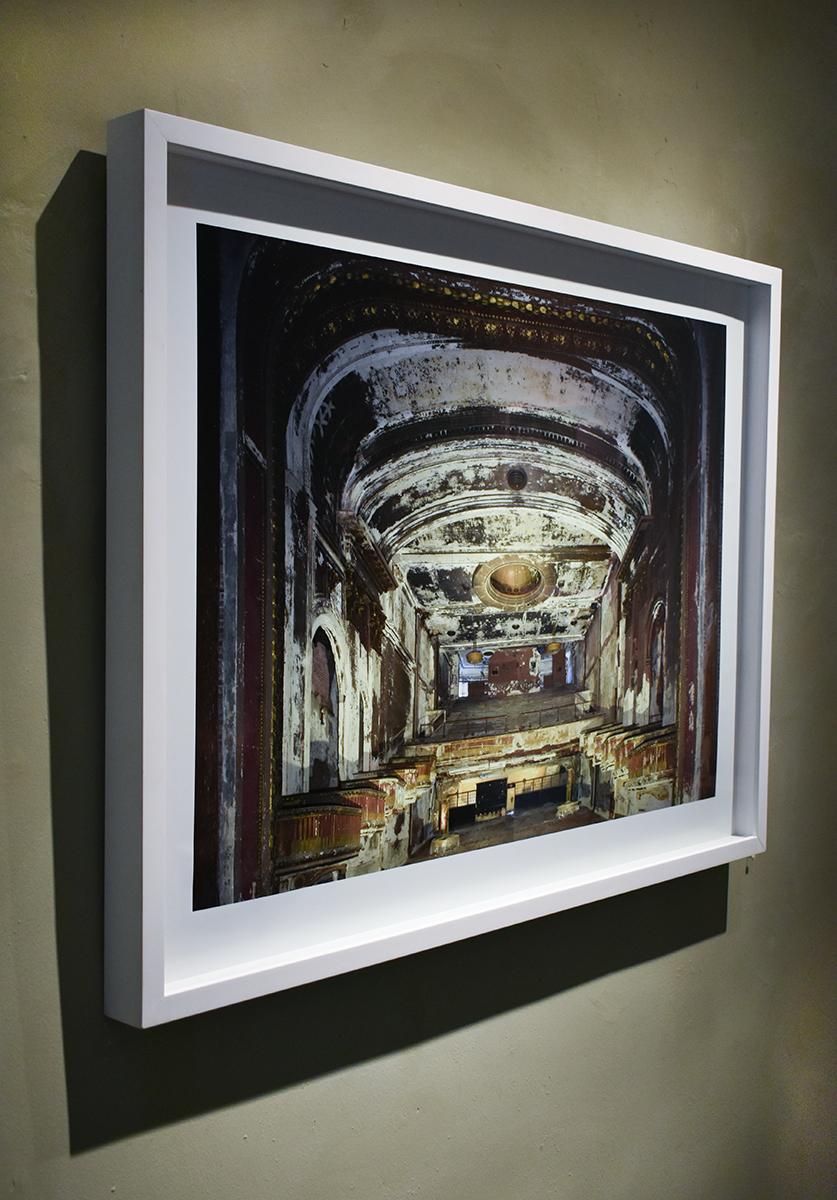 Contemporary color photograph of the interior of an abandoned theater 
25 x 35 inches unframed
31.5 x 41.5 inches in white wood frame with AR non-glare glass

This contemporary photograph of an abandoned theater interior was captured by New York