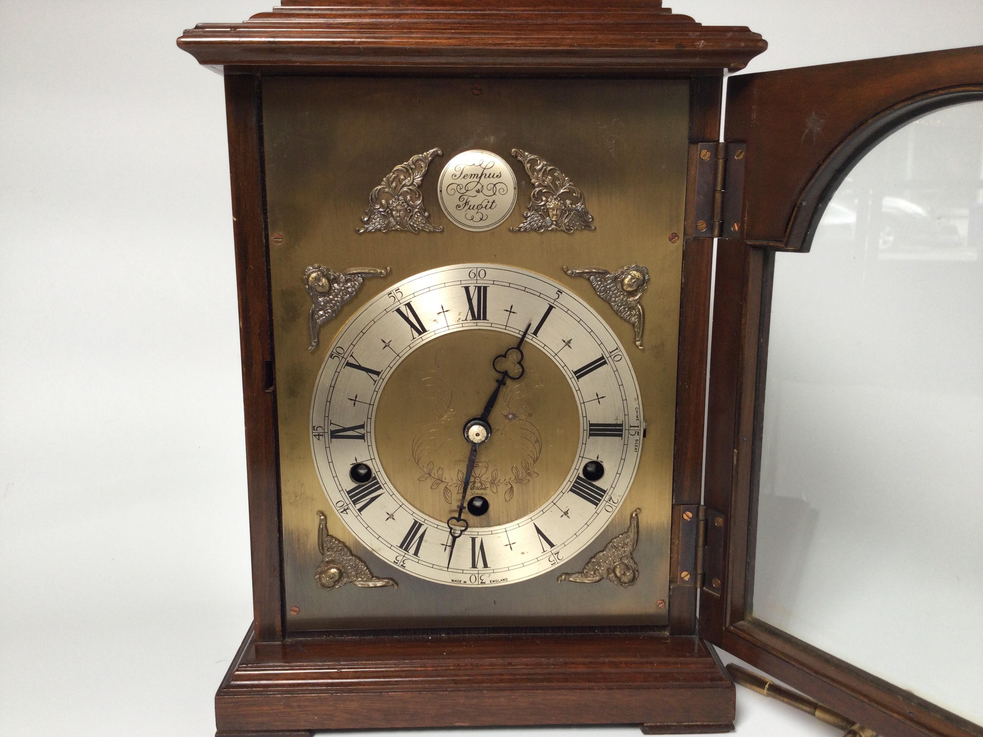 Elegant English bracket clock with mahogany case. Well made and chimes on every quarter hour with either Westminster or Whittington and also a silent feature. Elliott of London was considered the best clock maker in the 20th Century and made clocks
