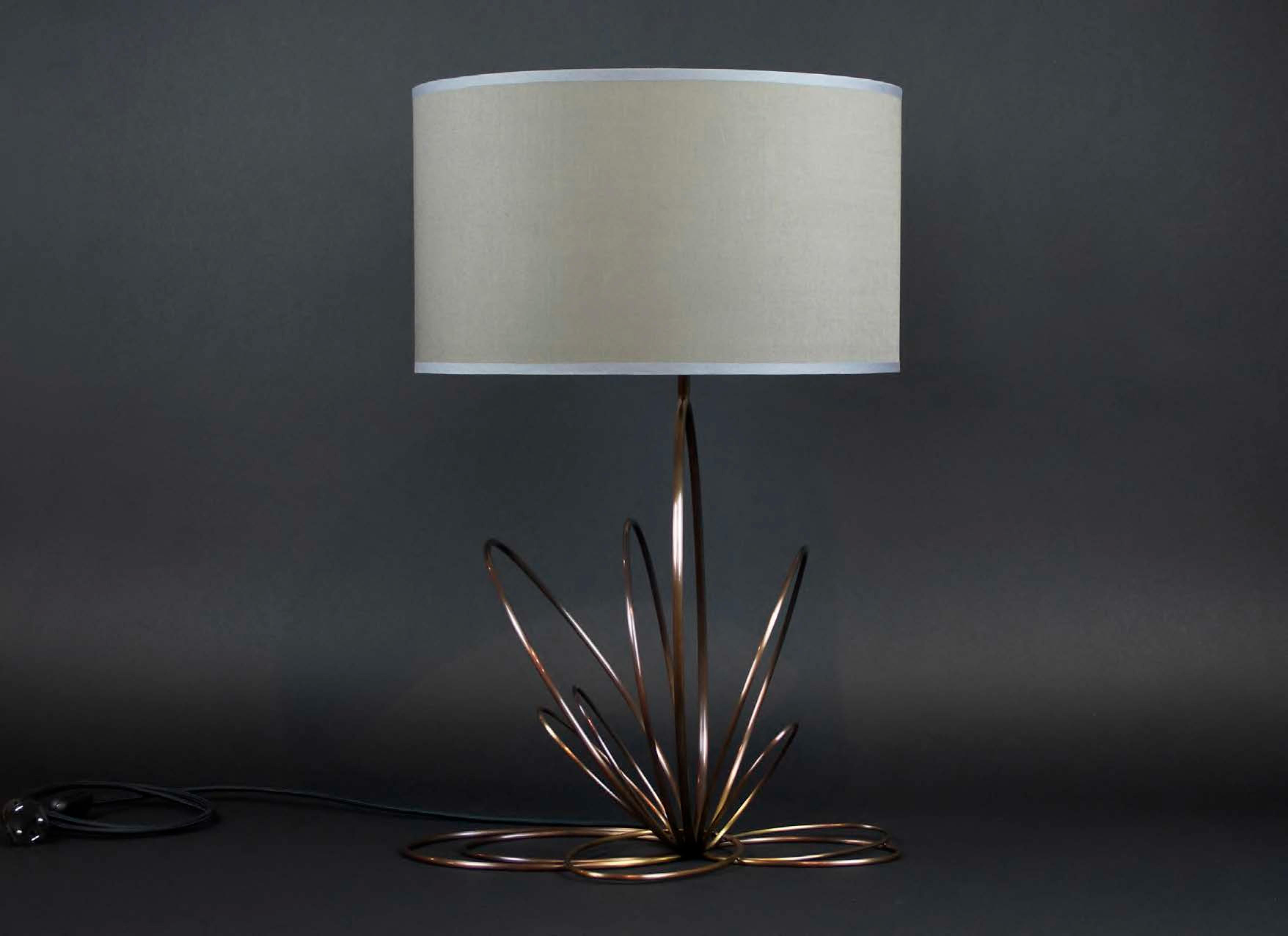 Ellipse 2 Table Lamp by Atelier Demichelis
Dimensions: W 41 x D 43 x H 63 cm
Materials: Patinated Brass, Grey Fabric Shade

Laura Demichelis

Laura was born & brought up in Provence, in the south of France.
Trained at the École Boulle in Paris, she