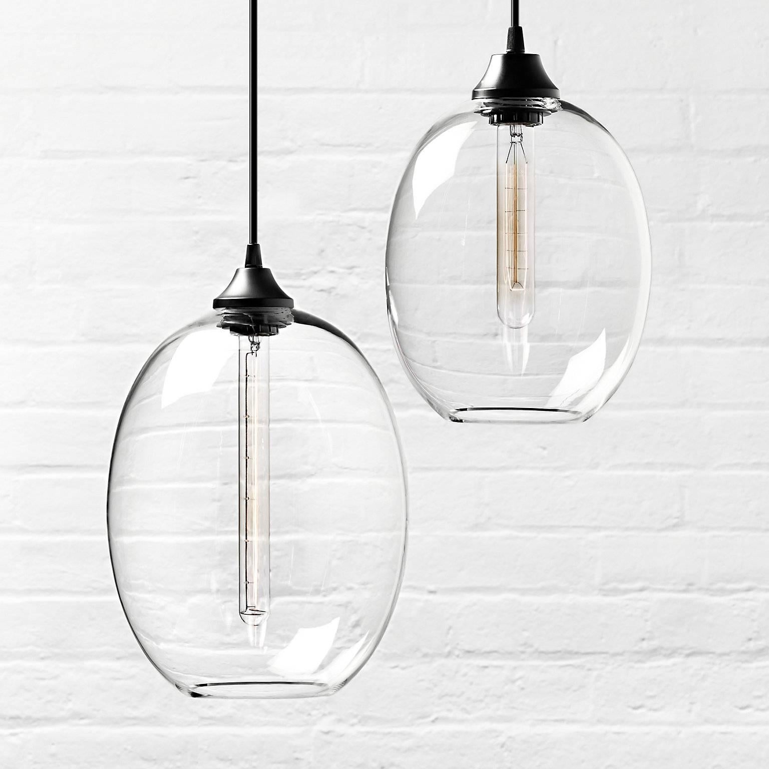 When paired together, the brilliant proportions of the Grand and Petite Ellipse pendants complement one another to create an elegant and distinctive design. Every single glass pendant light that comes from Niche is hand-blown by real human beings in