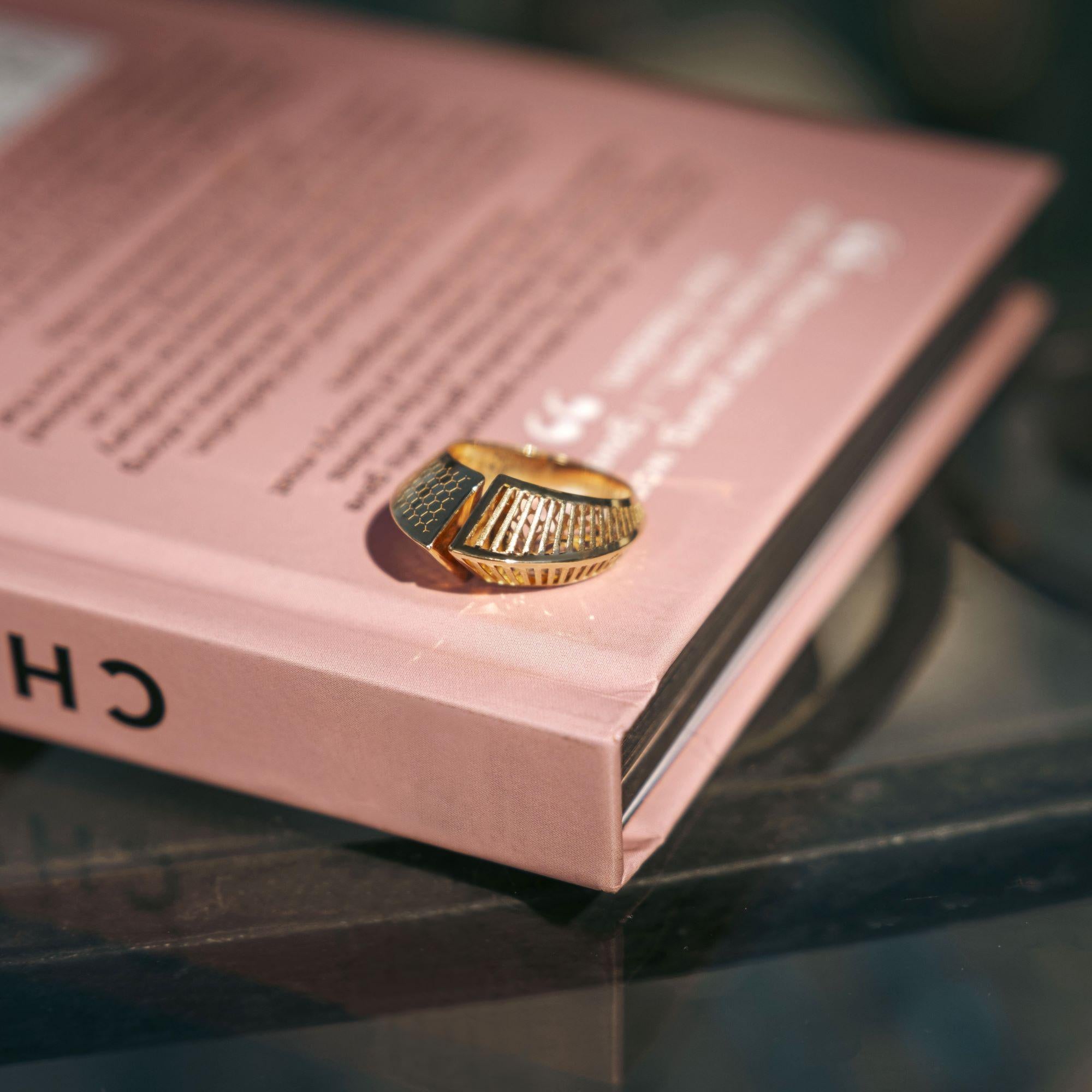 The Ellipsis 14K Solid Gold Open Ring features a modern, geometric design with a clean and balanced silhouette. Handcrafted from solid 14K gold, this adjustable ring combines lightweight comfort with contemporary style, making it suitable for both