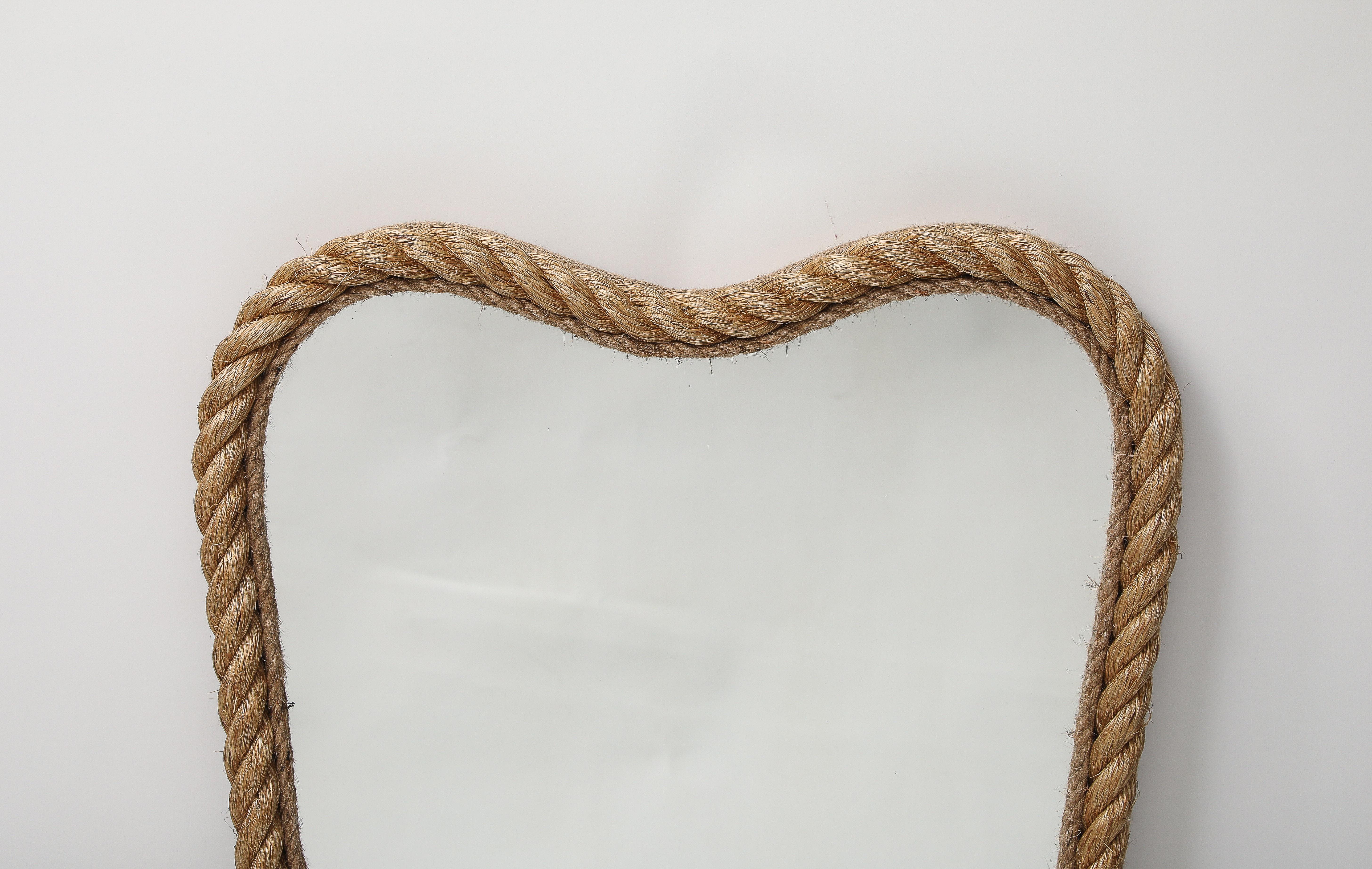 . This mirror made by a French artisan is in wood garnished with rope.It comes from a contemporary collection of mirrors inspired by the work of Audoux Minet..