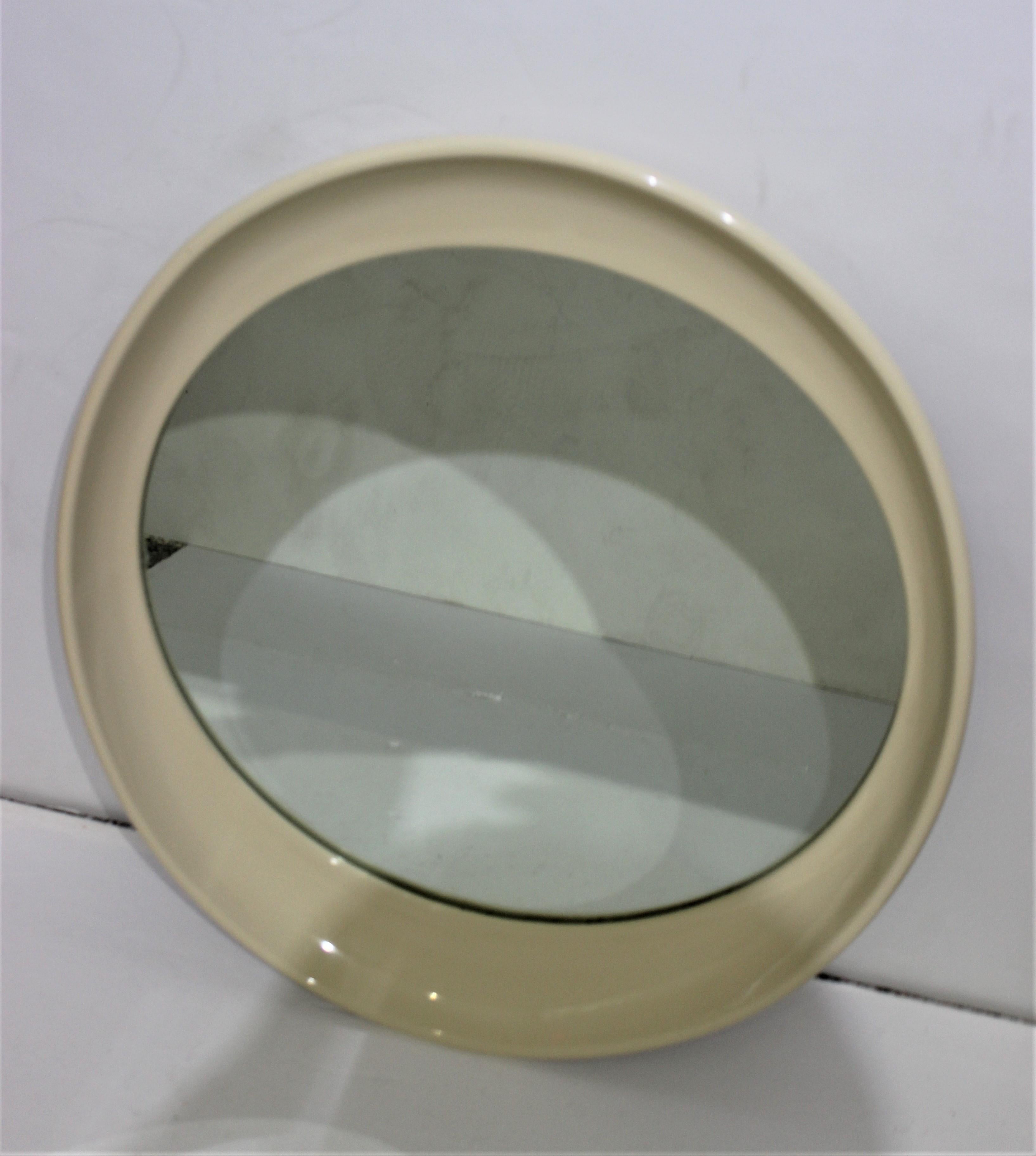 Elliptical mirror in cream color resin Italy late 20th century from a Palm Beach Estate.