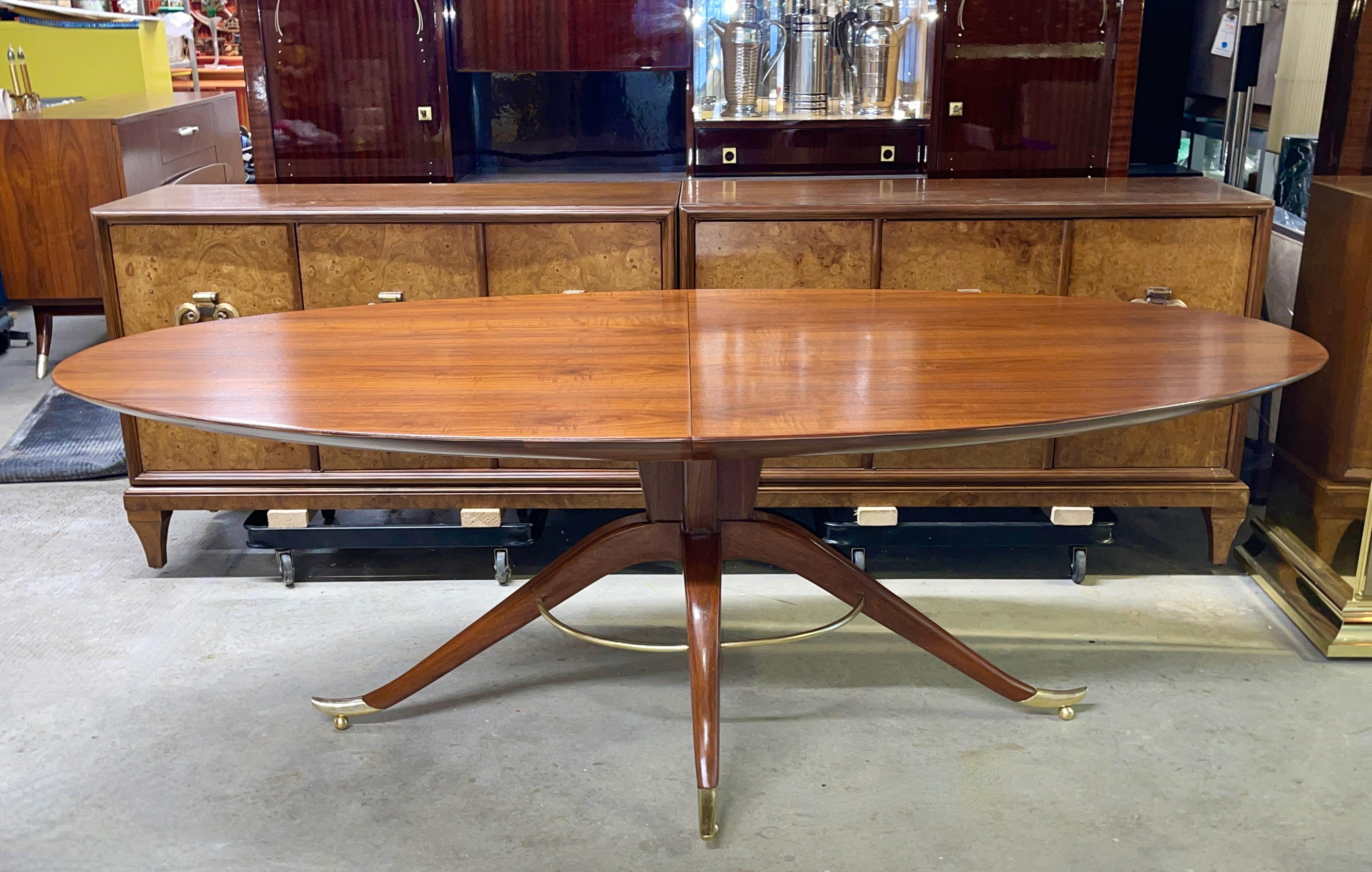 Designed and handcrafted in the 1954 by Adolfo Genovese for F & G Hand Made Furniture of 121 First Street East Cambridge, Massachusetts.
Absolutely breathtaking walnut dining table of Italian modernist styling with an elliptical oval top over a