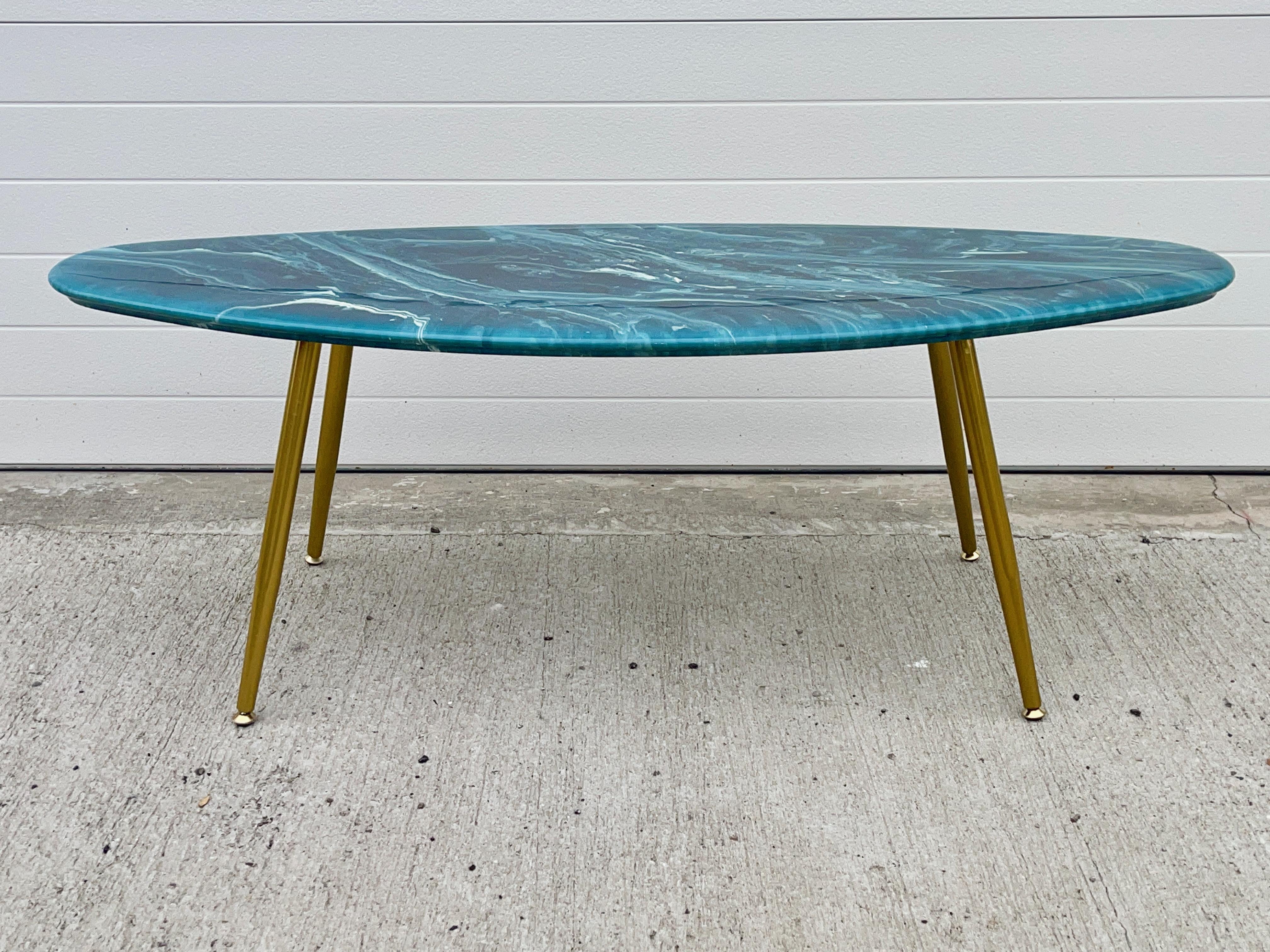 Surfboard shaped cocktail table comprised of a 