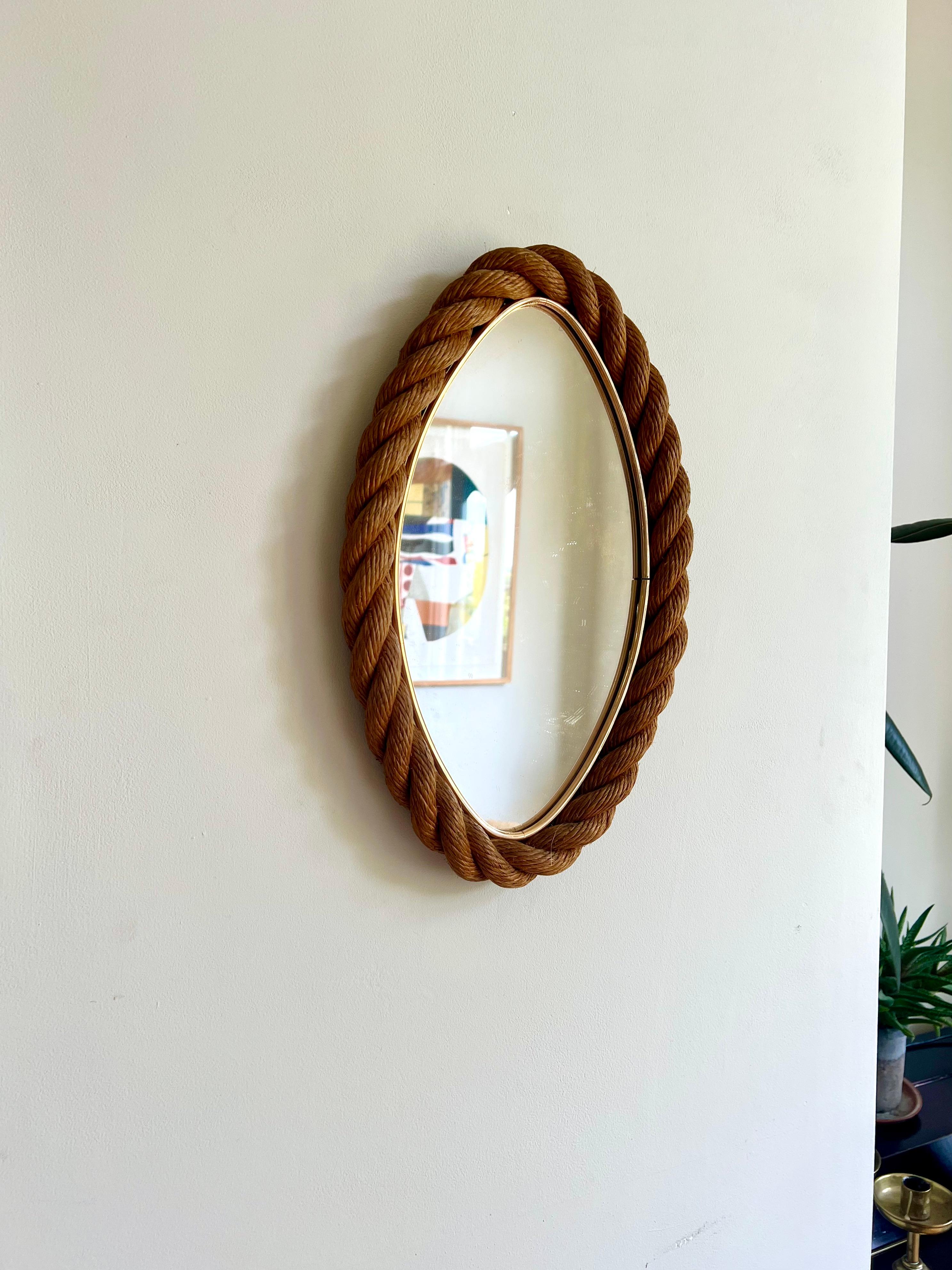 Elliptical wall mirror by Adrien Audoux and Frida Minet, France circa 1950-60.

Rope frame with brass banding around the glass, with original woven backing. 

A great example, in excellent, clean condition. The rope has a lovely rich colour, the