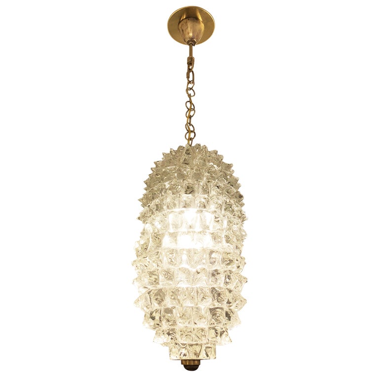 1940s Murano glass pendant by Ercole Barovier made in the “rostrato” technique with brass hardware. Mounts on a chain that can be adjusted as needed. Holds one E26 Socket.

Condition: Excellent vintage condition, minor wear consistent with age and