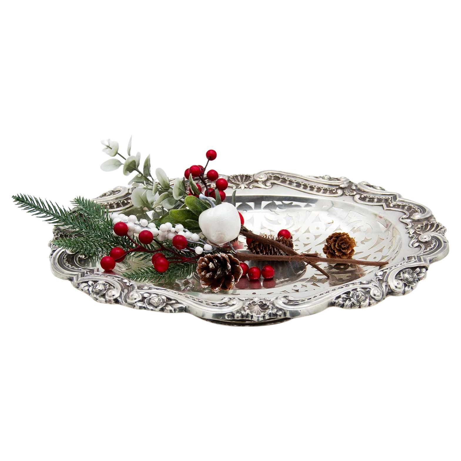 Elliptical silver fruit bowl with cut-out floral reliefs 
single foot For Sale