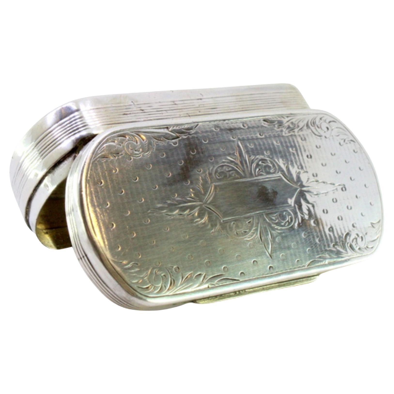 Elliptical silver snuff box with friezes and monogram cartouche