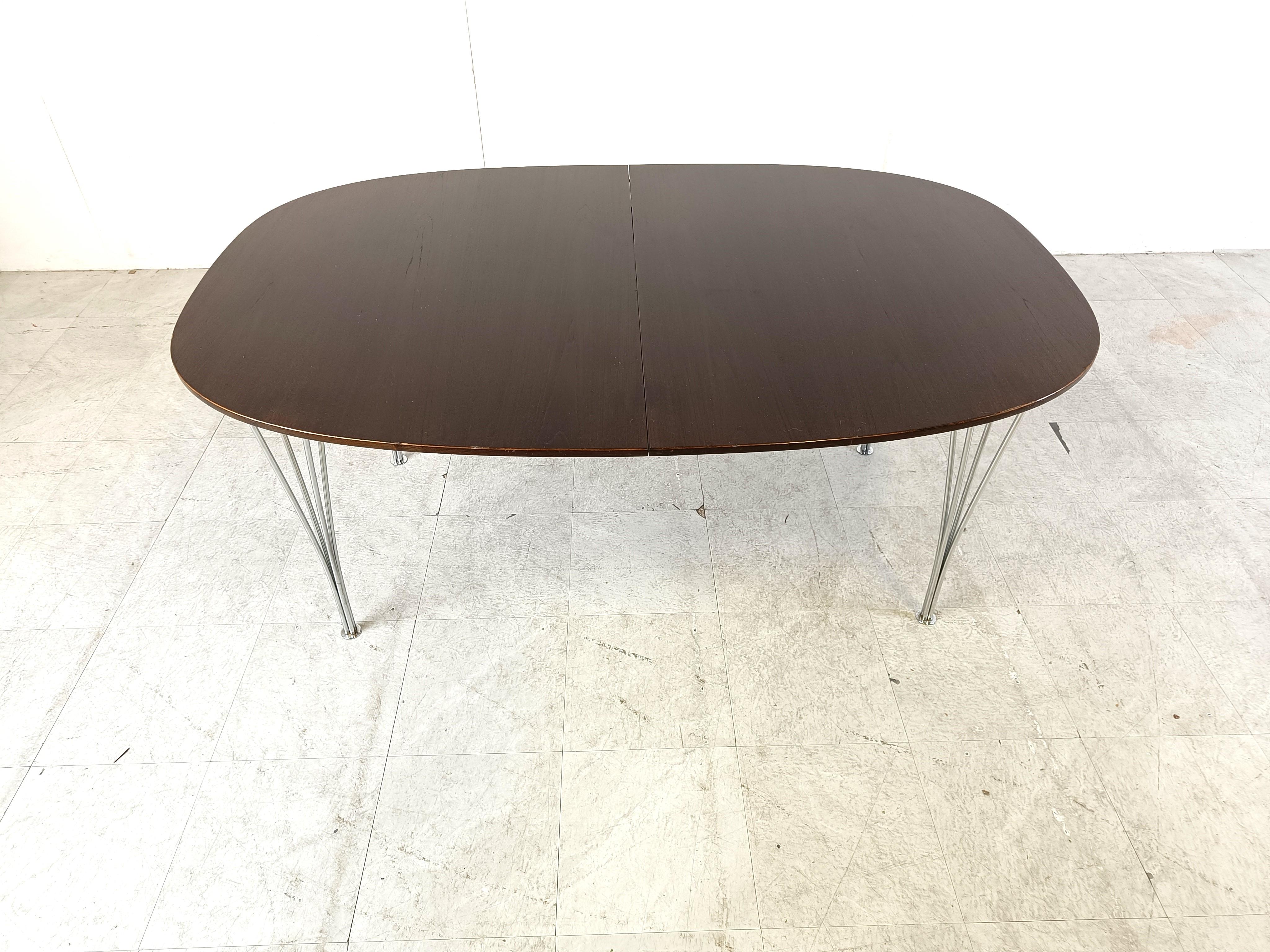 Vintage elliptical dining table model 7412 designed by Piet Hein and Bruno Mathsson for Fritz Hansen.

The table is extendable thanks to two extra table tops.

Fine and elegant metal wire legs.

Stamped underneath the table top with the makers mark
