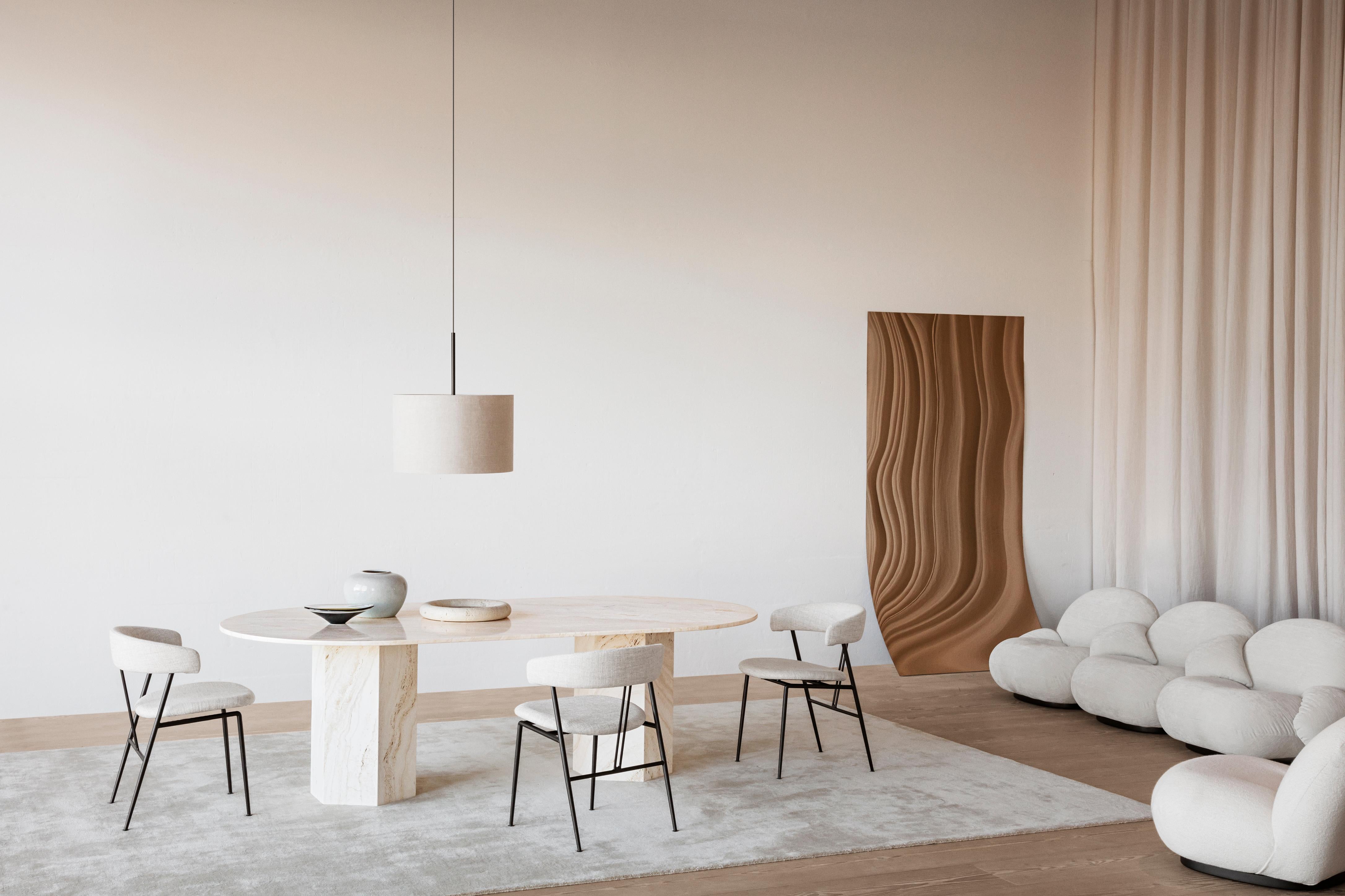 Elliptical Travertine epic table by GamFratesi for Gubi in Neutral white.

Named after the epic poems of ancient times, GamFratesi’s Epic Table for GUBI is a sculptural piece of furniture inspired by Greek columns and Roman architecture. Made in