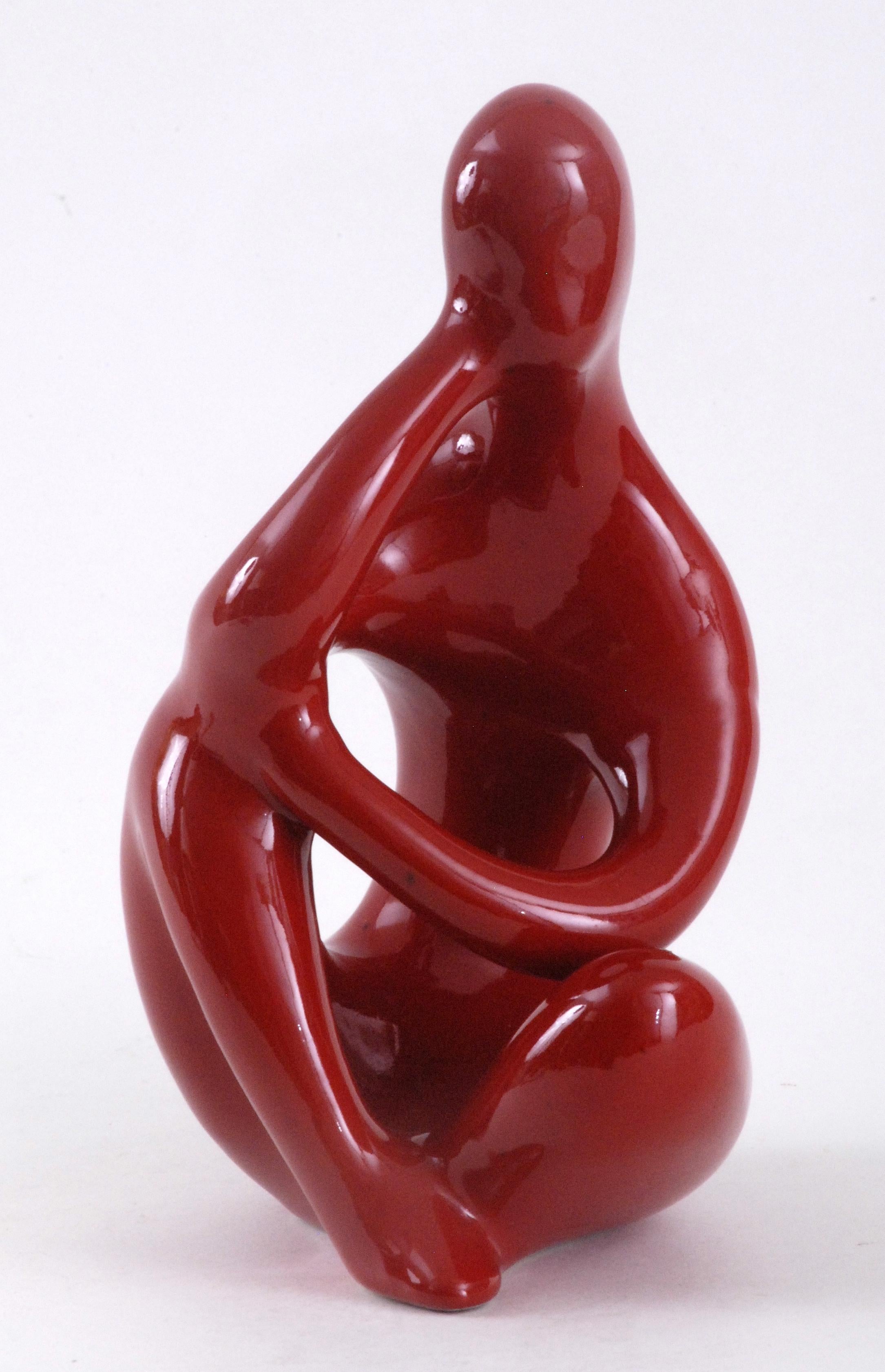 Ellis ceramics were set up in Melbourne in 1953 by Czechoslovakian couple, Dasa and Milda Kratochvil. Their work is mainly slip cast earthenware of which this red figure is an example. Highly stylized and with a brilliant rich red glaze this piece