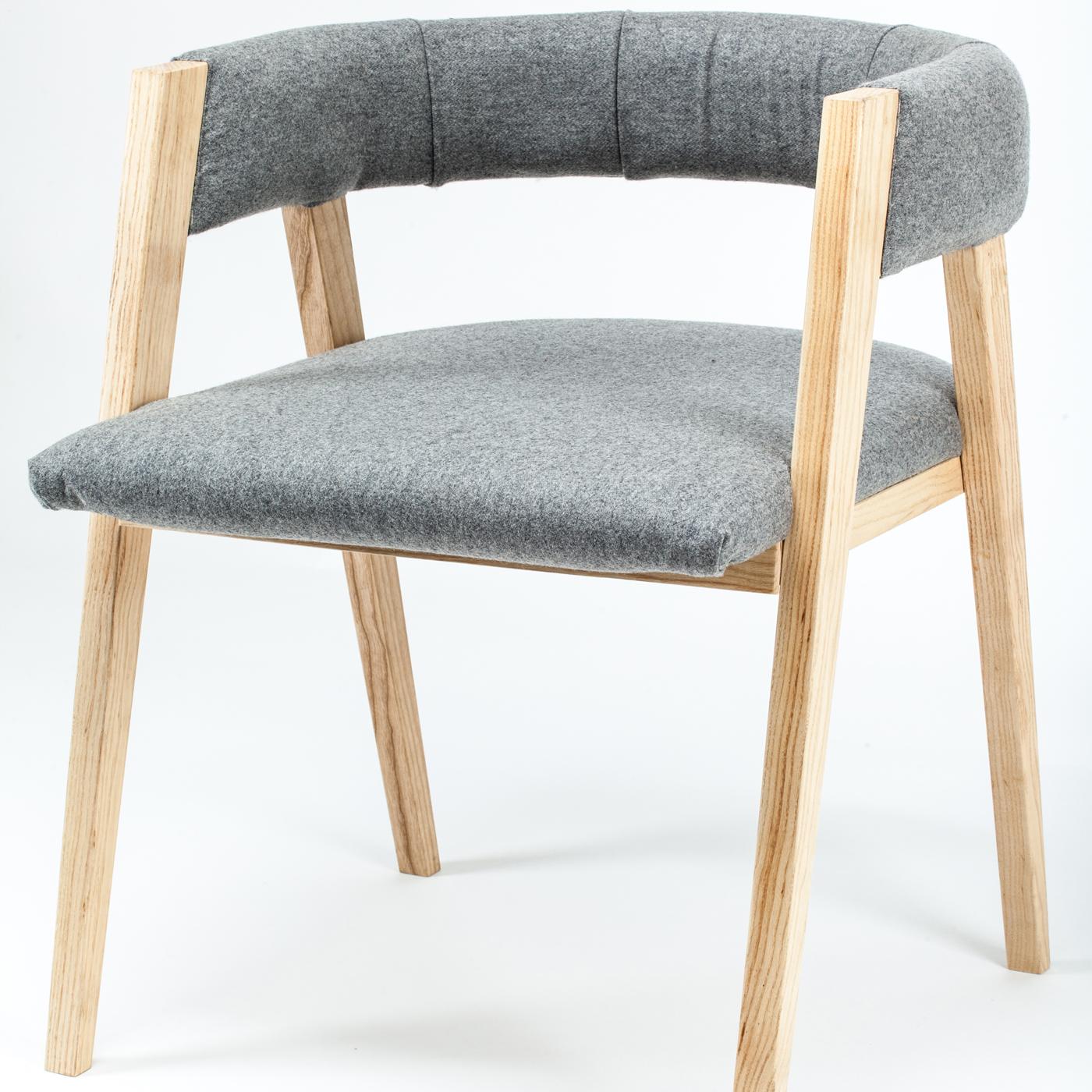 At first sight linear and austere, this chair conveys great visual lightness in a comfortable and elegant Silhouette. The perfectly balanced ashwood frame showcases four spiked legs that support a padded semi-circular backrest and seat that are