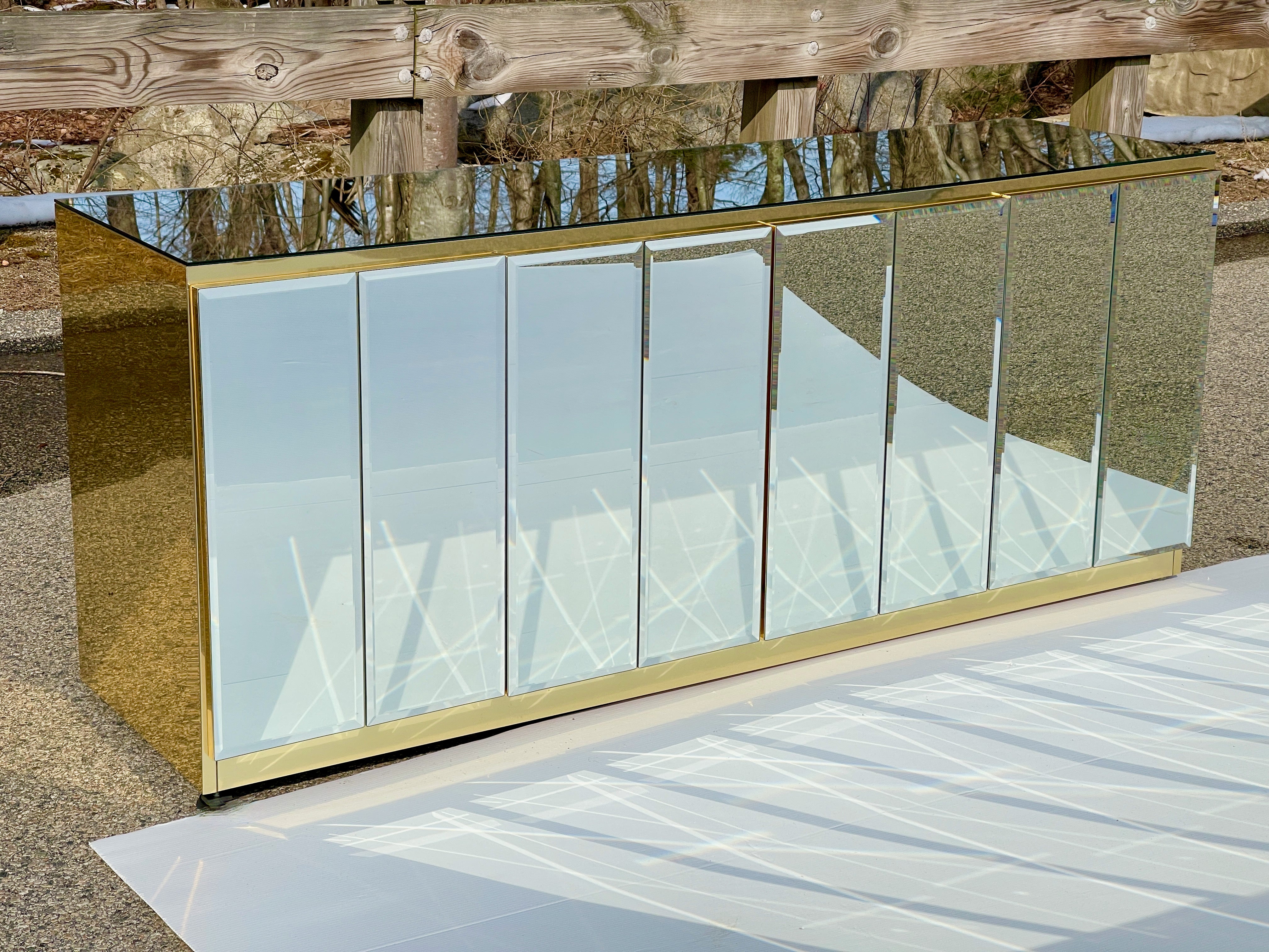 SATURDAY SALE

Four door sideboard by O.B. Solie for Ello Furniture Manufacturing Corp. clad and trimmed in mirror polished brass anodized aluminum with mirrored glass top and double panels of beveled mirrored glass on all four doors.
Both sets of