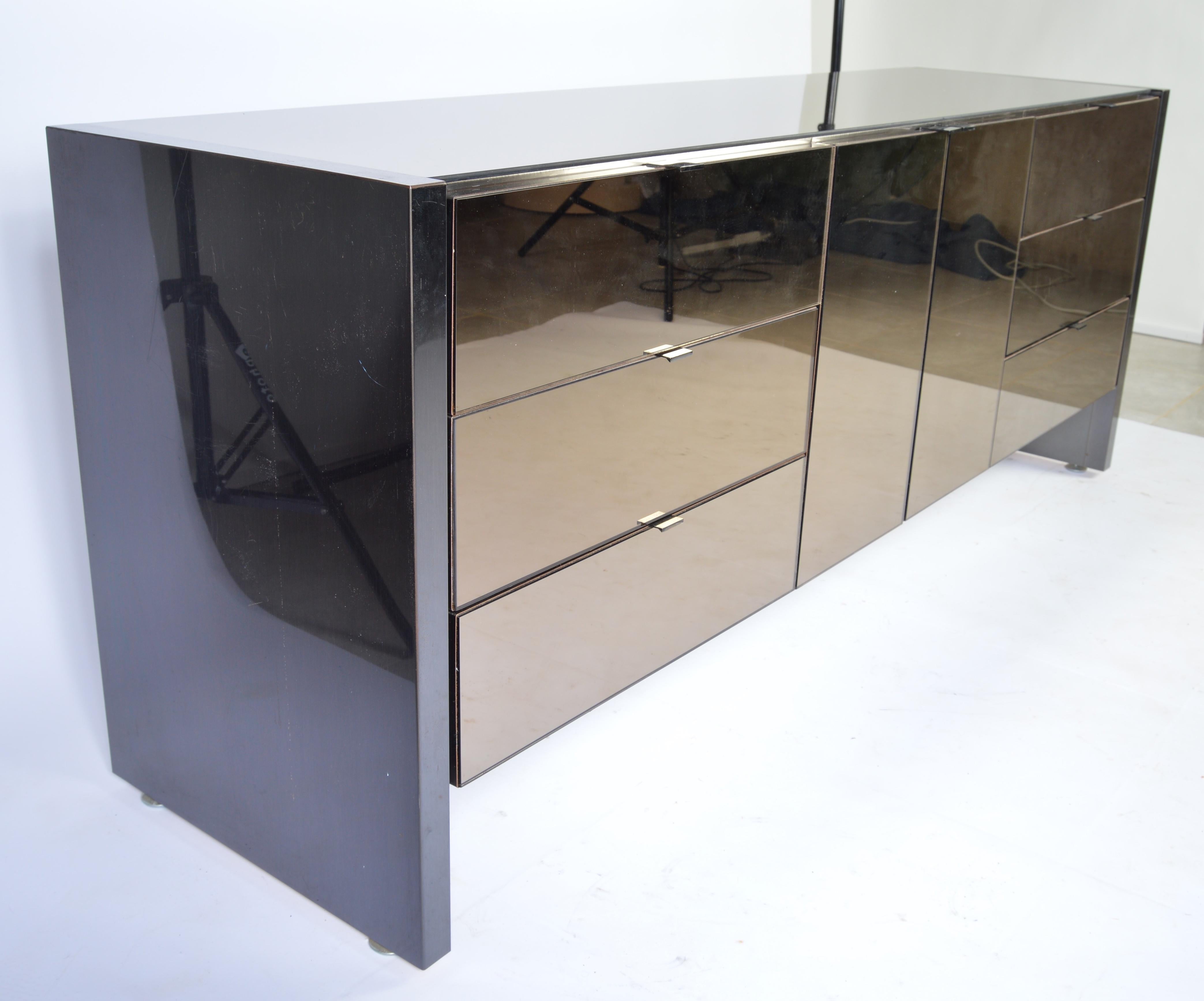 A beautiful smoked mirror and chrome credenza by Ello Furniture having charcoal steel sides, ample centre storage and six drawers, circa 1970.