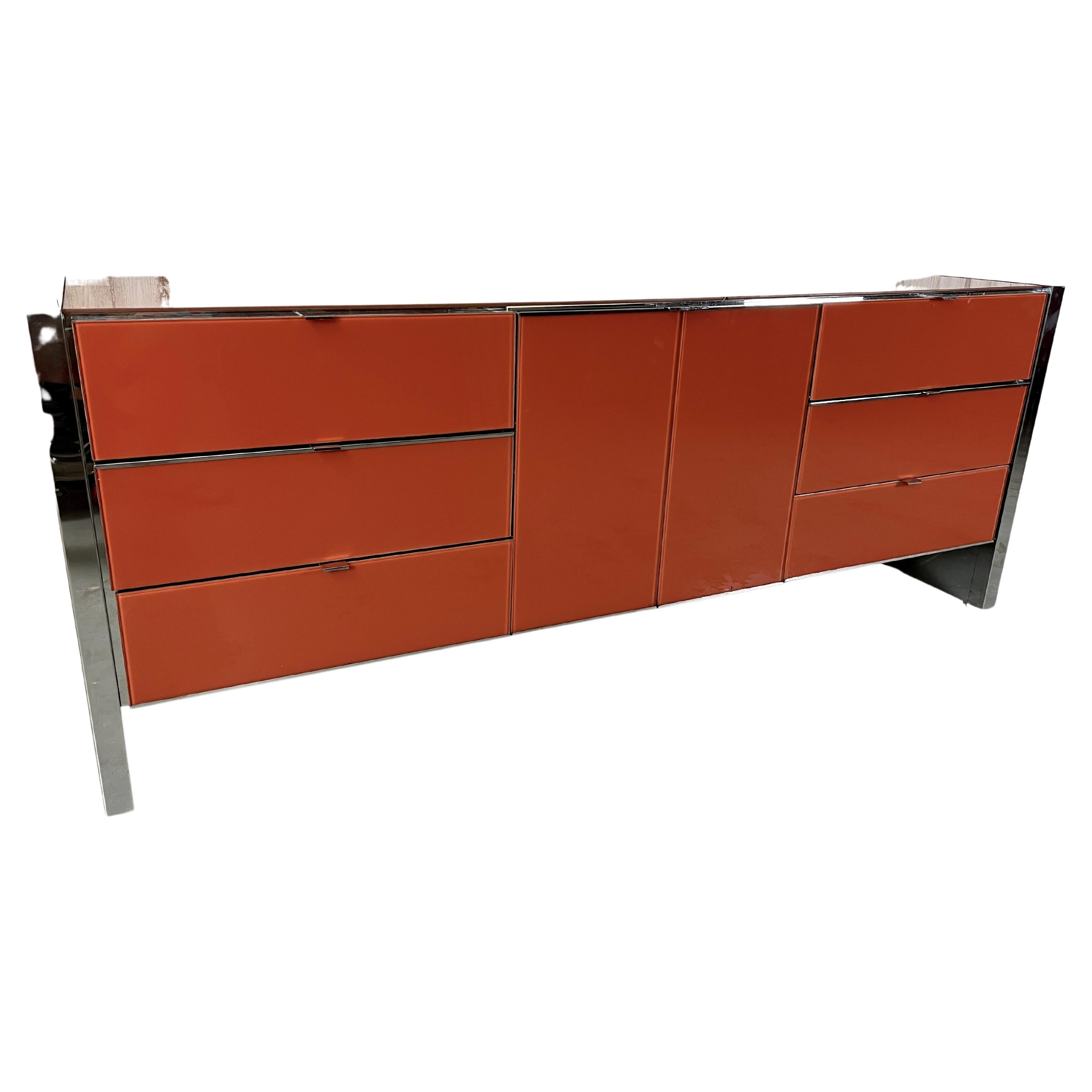 Ello Lacquered glass and chrome credenza. Burnt Orange lacquered glass with chrome sides, trim, and handles.
