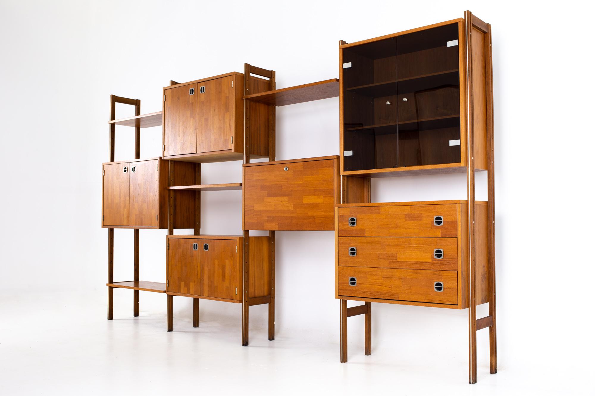 Ello mid century teak chrome and smoked glass 4 bay freestanding wall unit
Wall unit measures: 126 wide x 16 deep x 73 inches high  

All pieces of furniture can be had in what we call restored vintage condition. That means the piece is restored