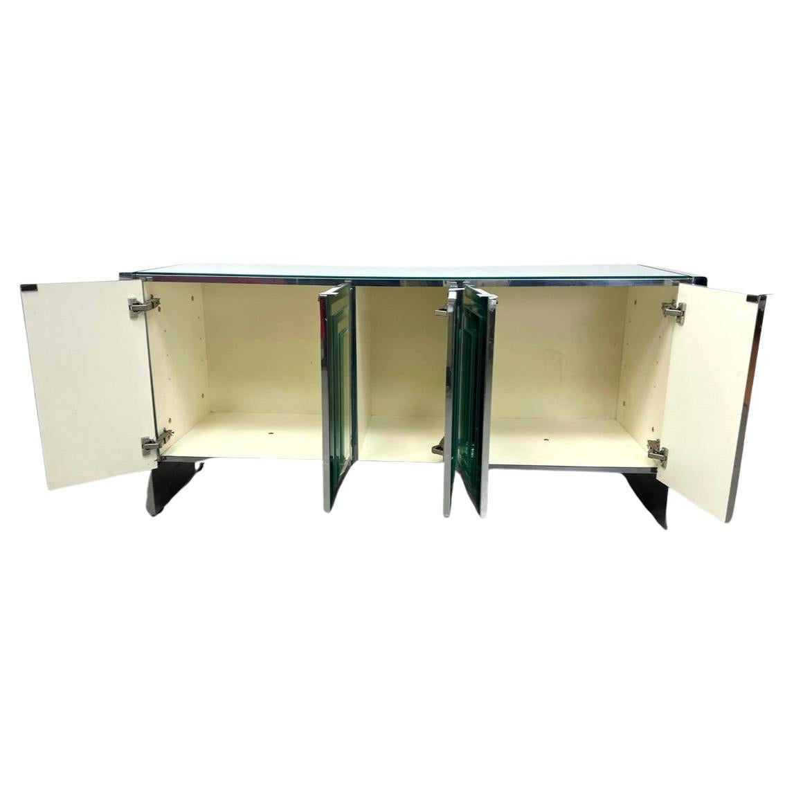Ello Post Modern Mid century layered Glass Mirror  5 door Credenza or sideboard C. 1980s. Long low Glass staggered Mirror door Credenza with 5 cabinet doors. Has white laminate inside with chrome accents. Come with (2) white laminate adjustable