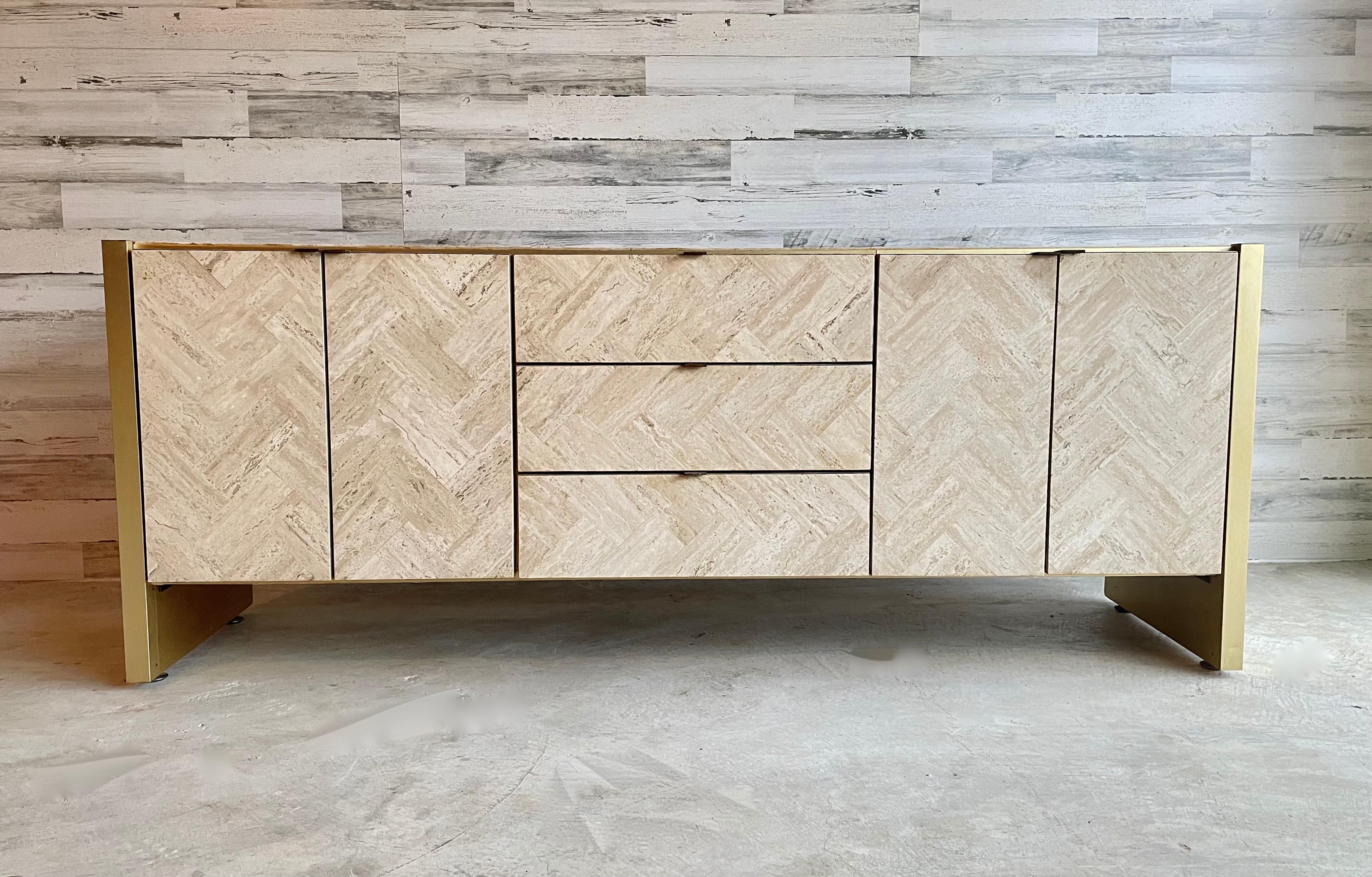 Ello travertine and brushed brass credenza / sideboard. Adjustable legs for leveling. Drawers and doors for all kinds of storage. Very good condition for its age. These are very rare to find!