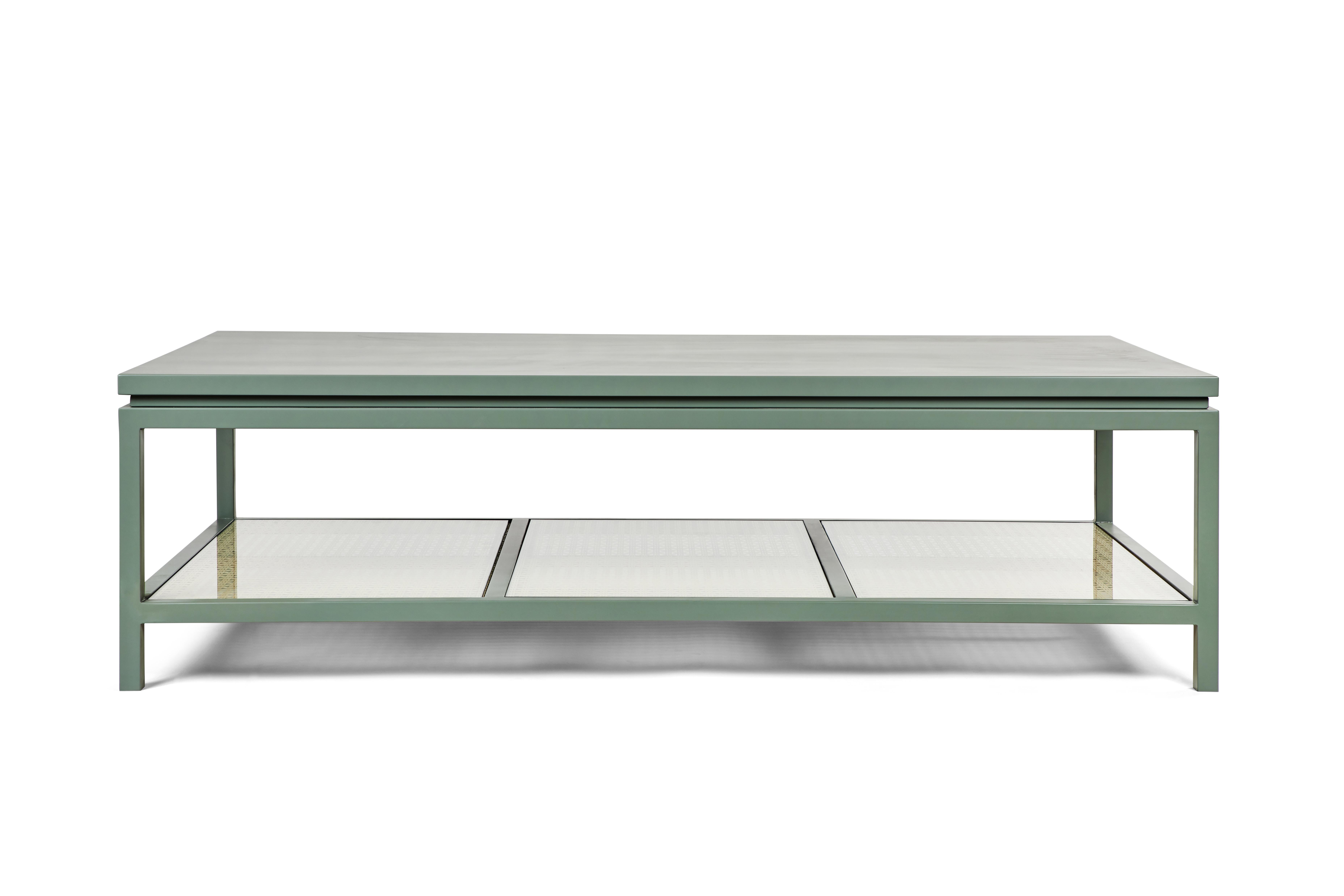 Our oversized Ellwood Coffee Table celebrates the colors of the California landscape. Shown here in our Eucalyptus finish, the hand-made table pairs a matte-satin lacquer with cane and clear starphire glass. Perfect for displaying a coffee table