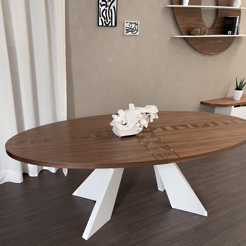 Elegant 8 seater oval dining table, with Canaletto wood top and modern X-shaped supporting structure. The elliptical shape of the top allows the placement of this important table even in small spaces. This table, closed (220 cm x 100 cm),