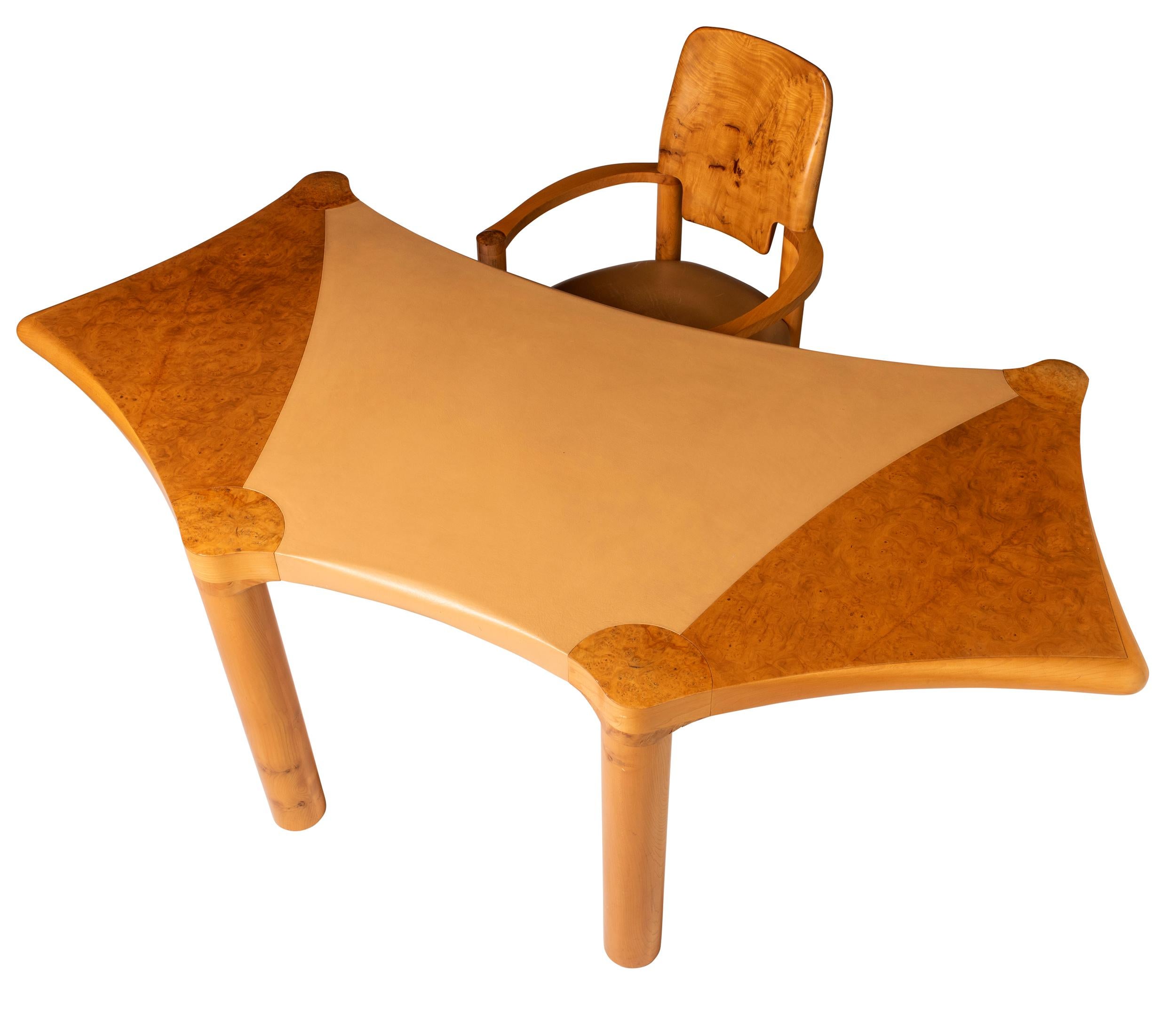 Scrivania e sedia in olmo e burr, disegnata da John Makepeace.
Realizzato da Mark Coray nei laboratori Makepeace.
Di forma sagomata con supporti per colonne rotonde.
Inserti in pelle sulla parte superiore e sulla seduta.
Inscritto sul lato inferiore