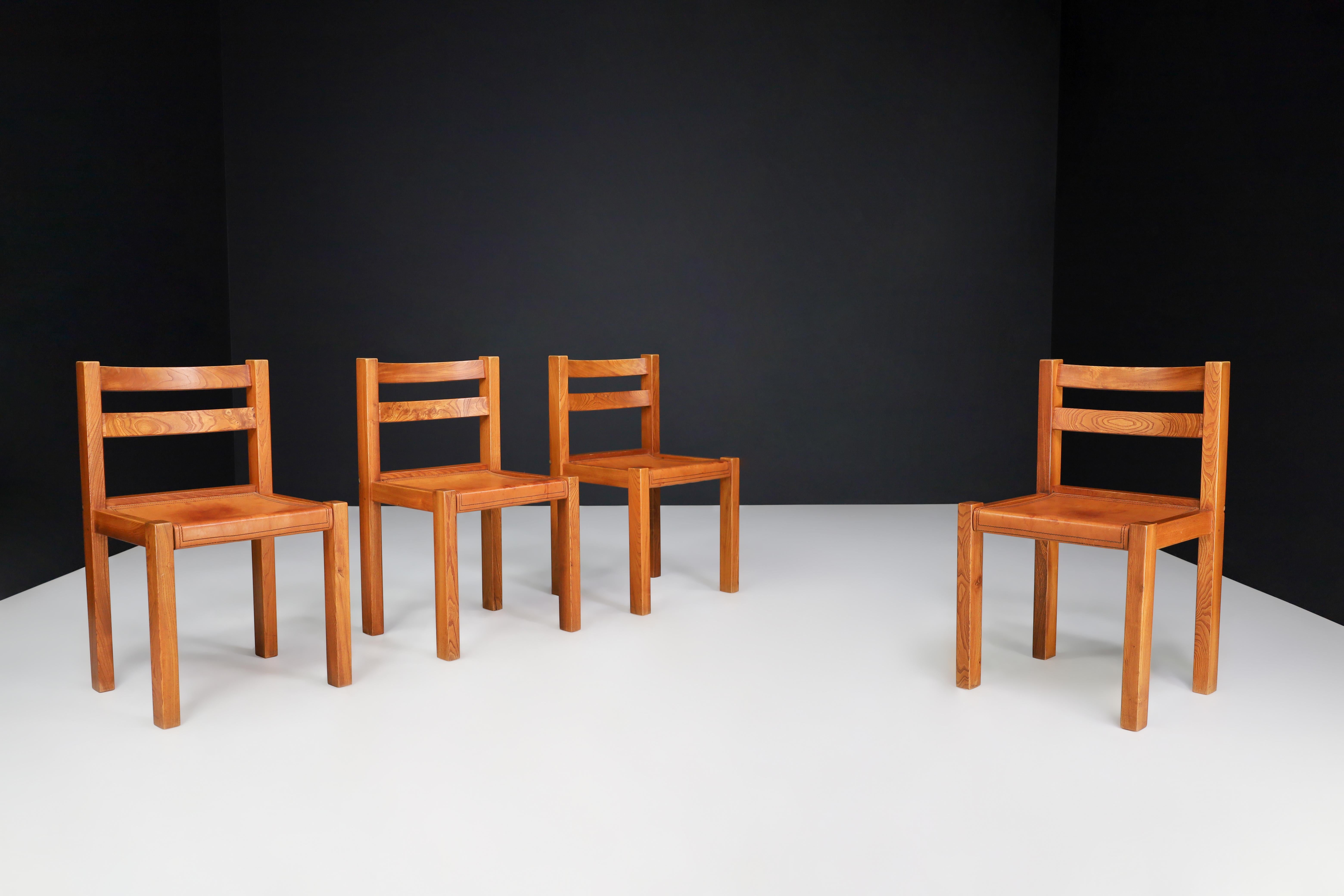 Elm and Cognac Leather Dining room Chairs set of 4, Italy 1950s

This set of four dining chairs was manufactured in Italy in the 1950s and is made of elm wood and cognac-colored leather. The chairs have a simple design with straight lines and are