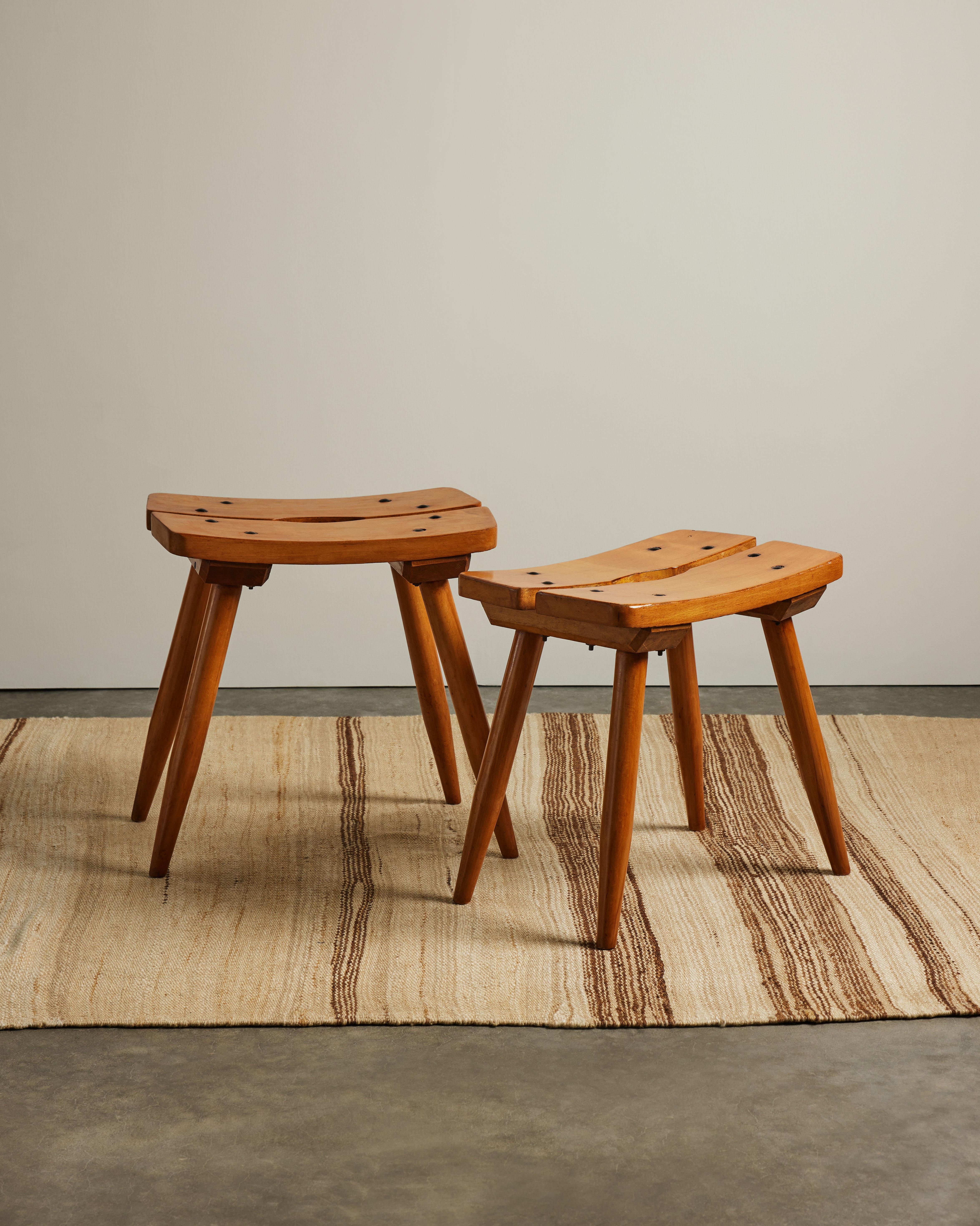 Hand carved elm stools with iron nails, designed and made in France by famed workshop Atelier Marolles, lead by Jean Touret. Six available.