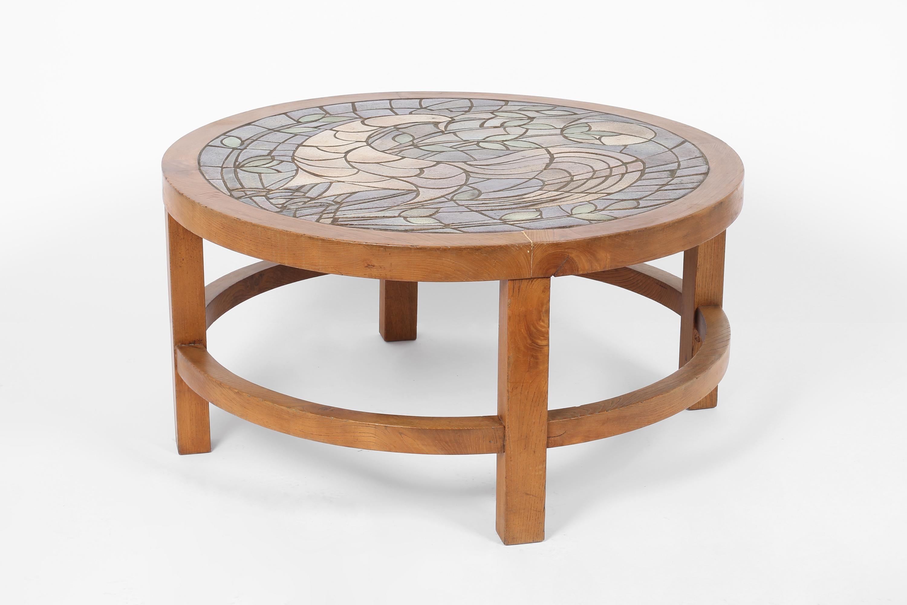 A unique & elegant circular coffee table in solid elm, with inset glazed ceramic tile top. The stylised cockerel mosaic created by ceramist & painter Marie Poirier of Montargis, Loiret. French, c. 1950s.