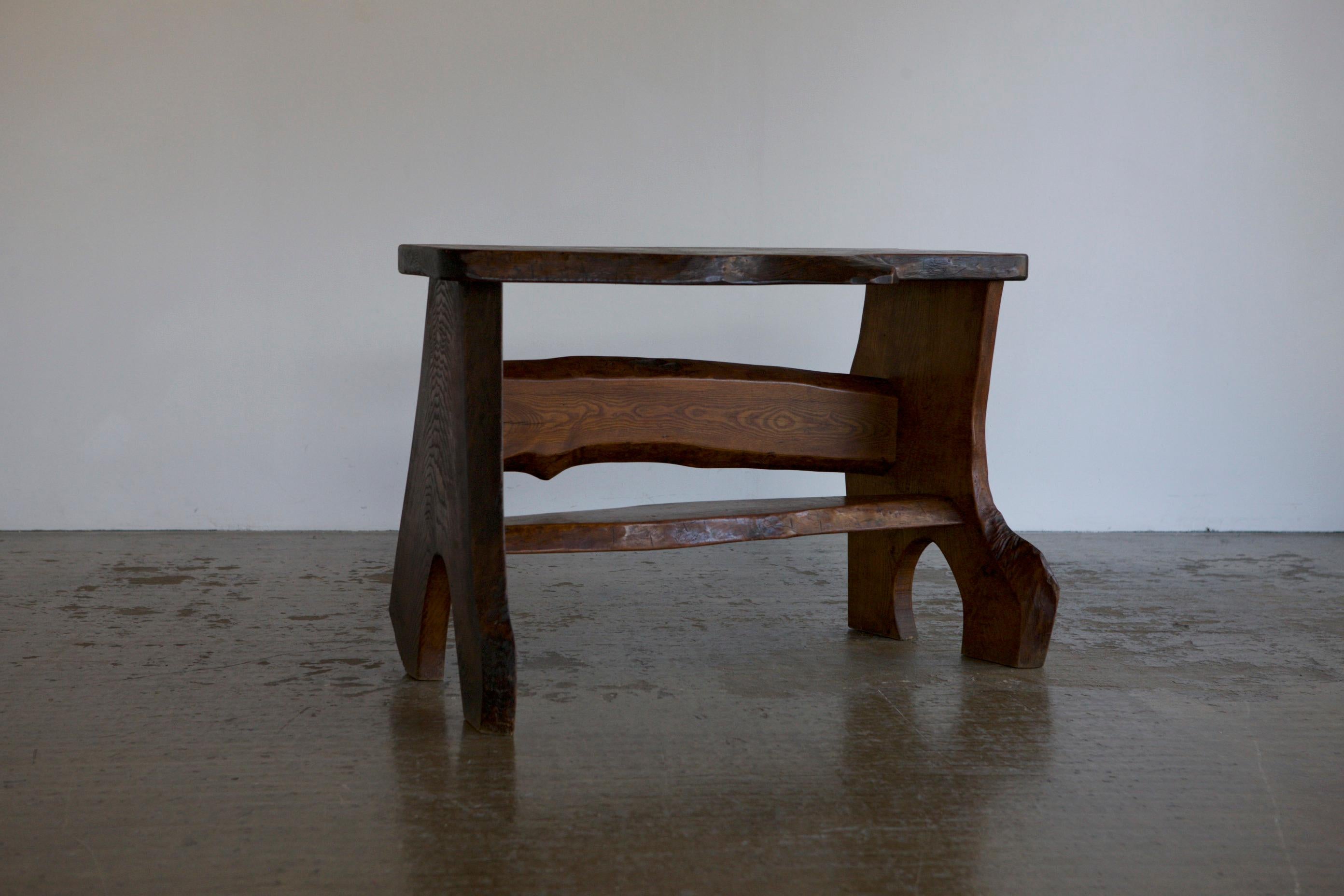 An organic console made with slabs of elm where the natural shape of the wood has informed the final sillouette of the piece.
